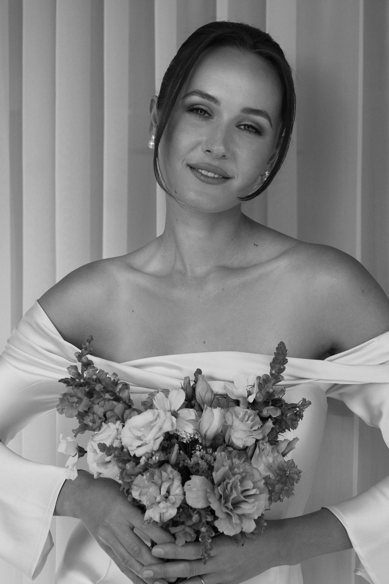 Bride holding bouquet after makeup by Natalia MUA, soft glam bridal look in Winnipeg.