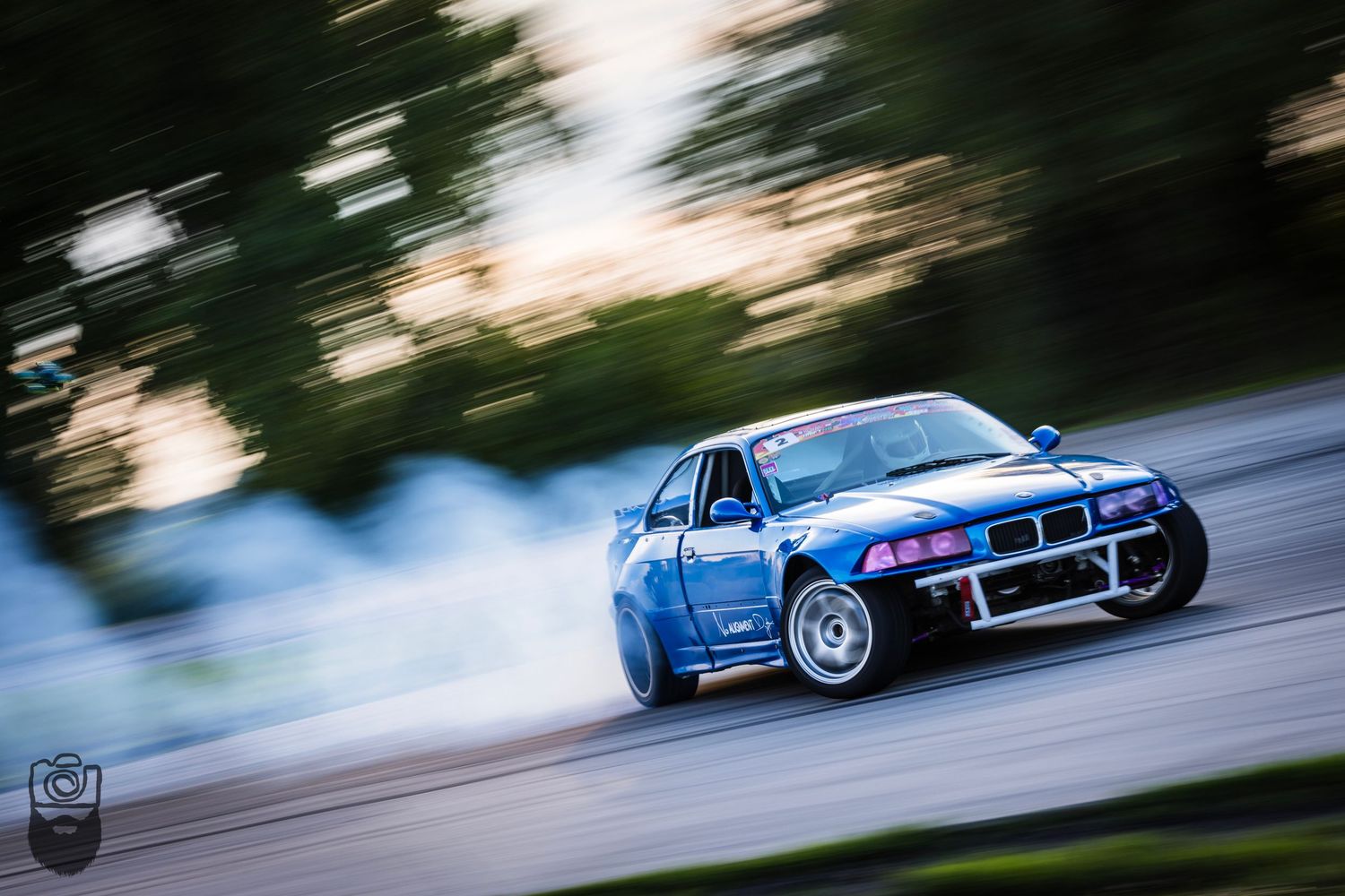 BMW M3 drifting through a corner with dramatic motion blur.