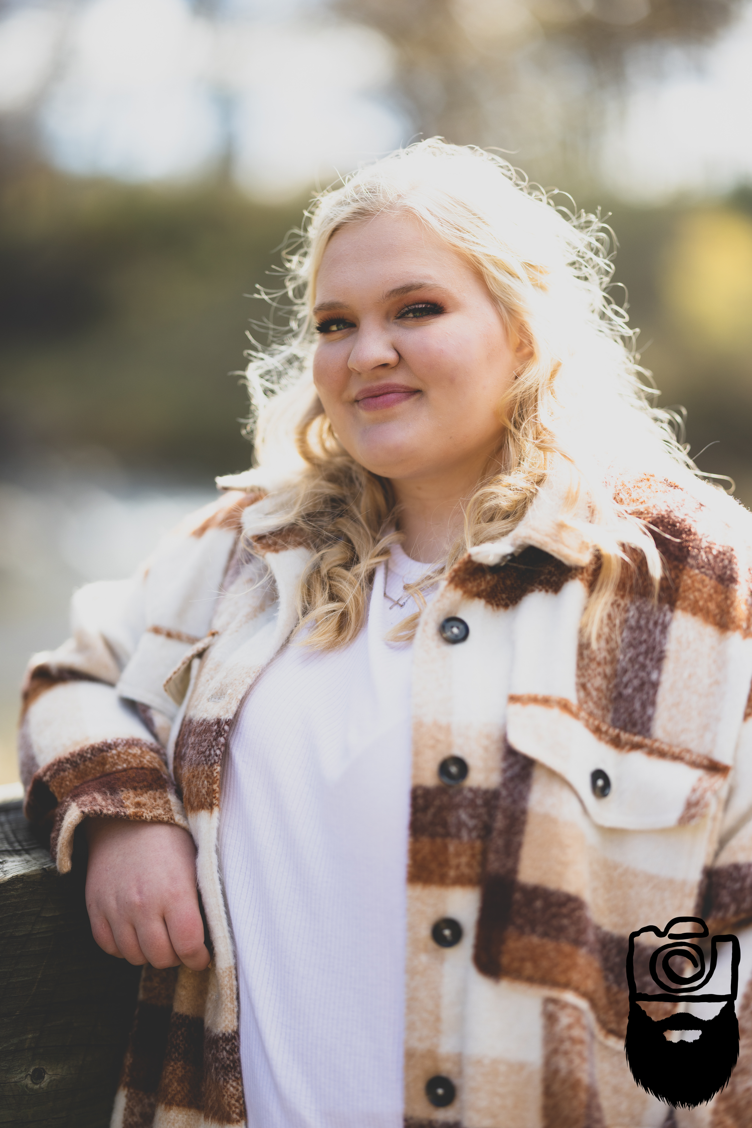 Person wearing a cozy brown and white plaid coat outdoors in autumn.