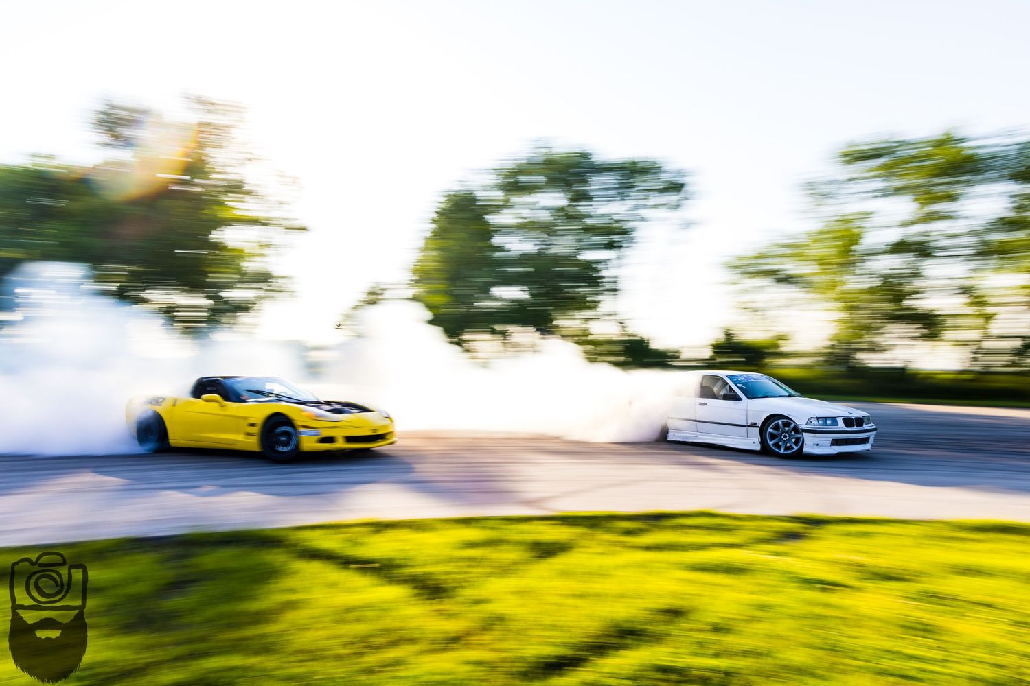 Sports cars drifting against a bright natural background with motion effects.