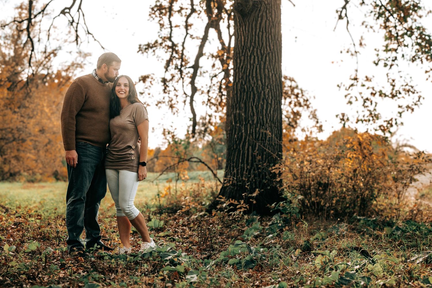 Natural outdoor portraits captured under large trees in autumn lighting.