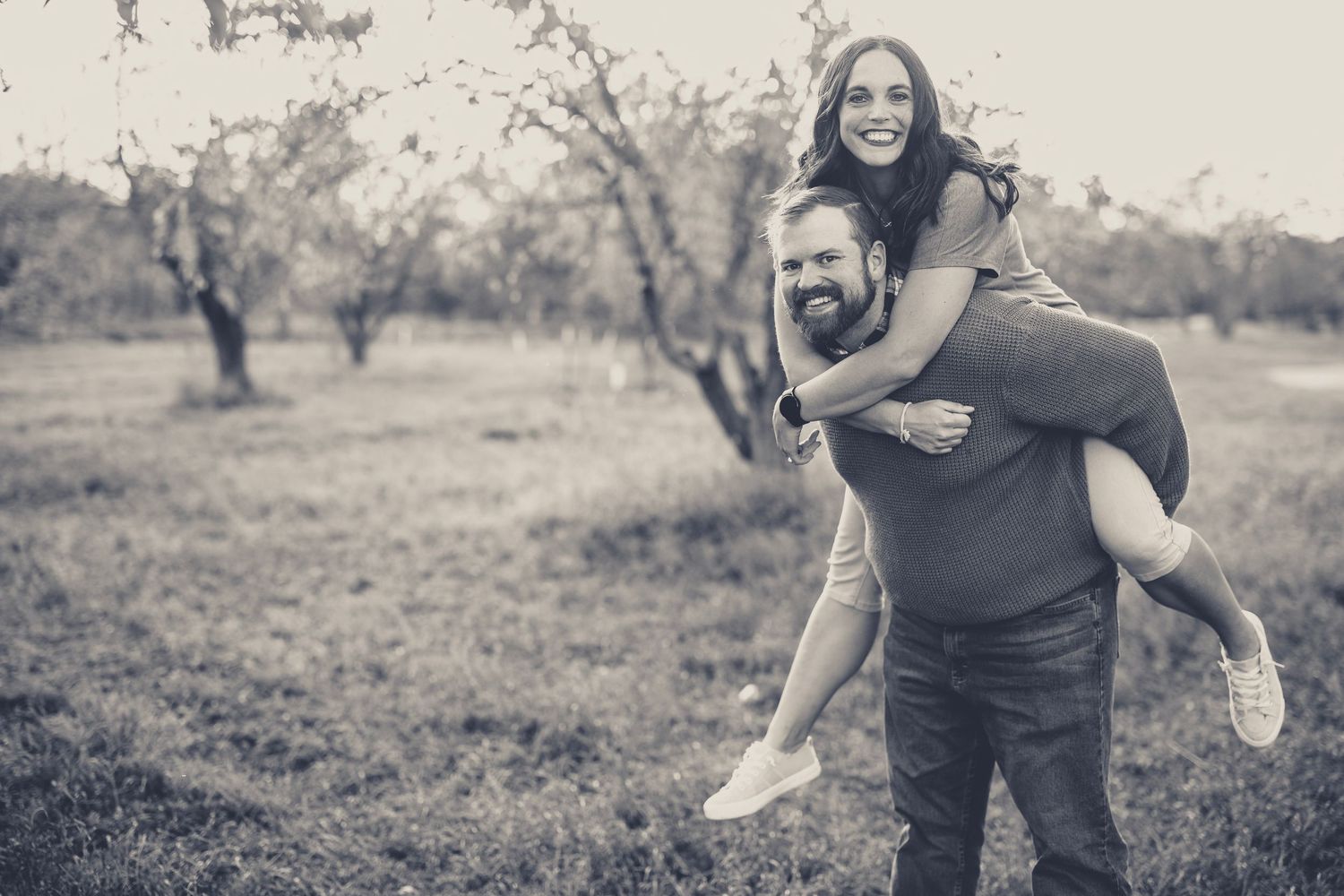 Candid black and white photos showing joyful moments in an outdoor setting.
