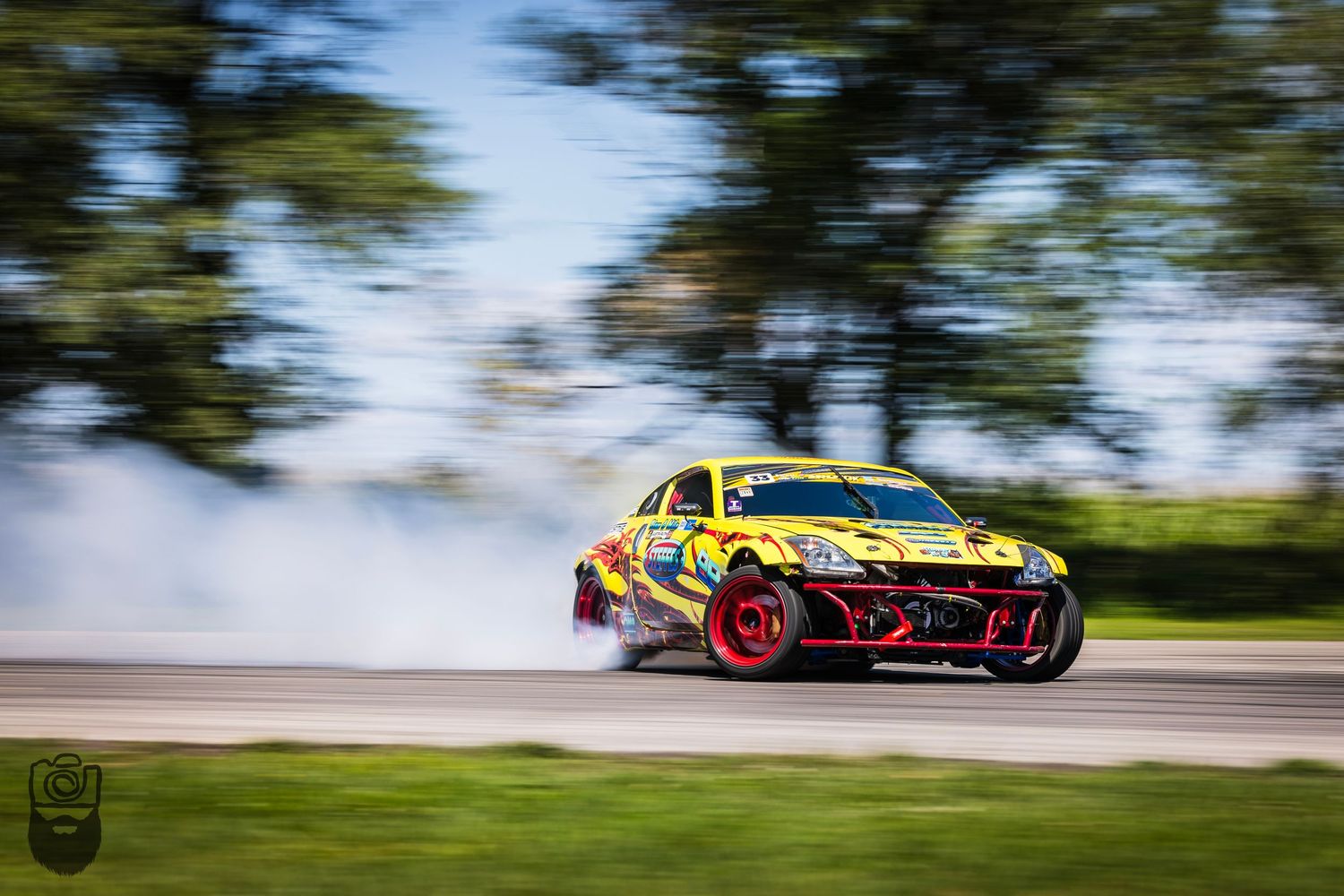 Race cars performing synchronized drifting maneuvers with motion blur effect.