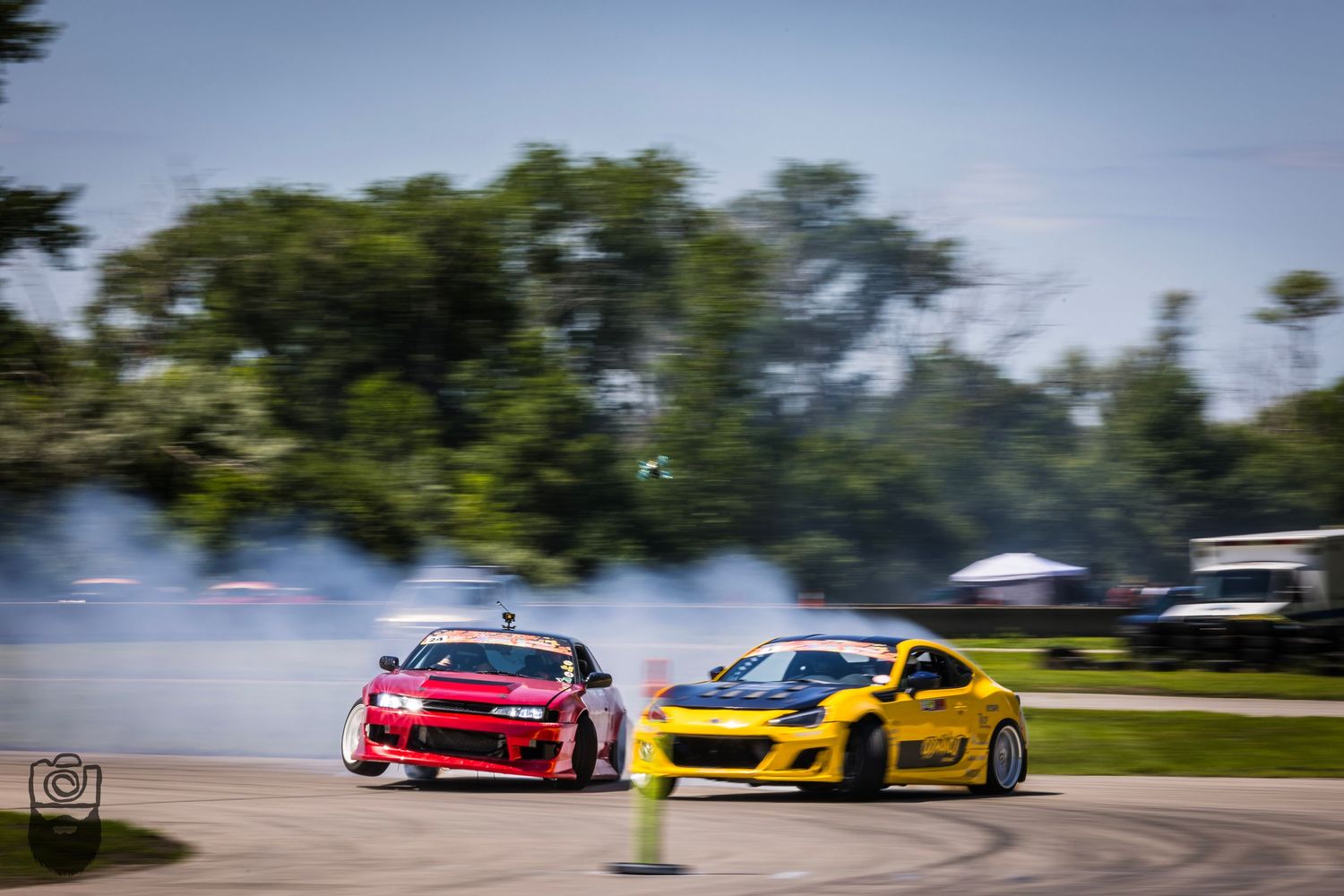 Yellow and red sports cars racing on a track with motion blur effect.