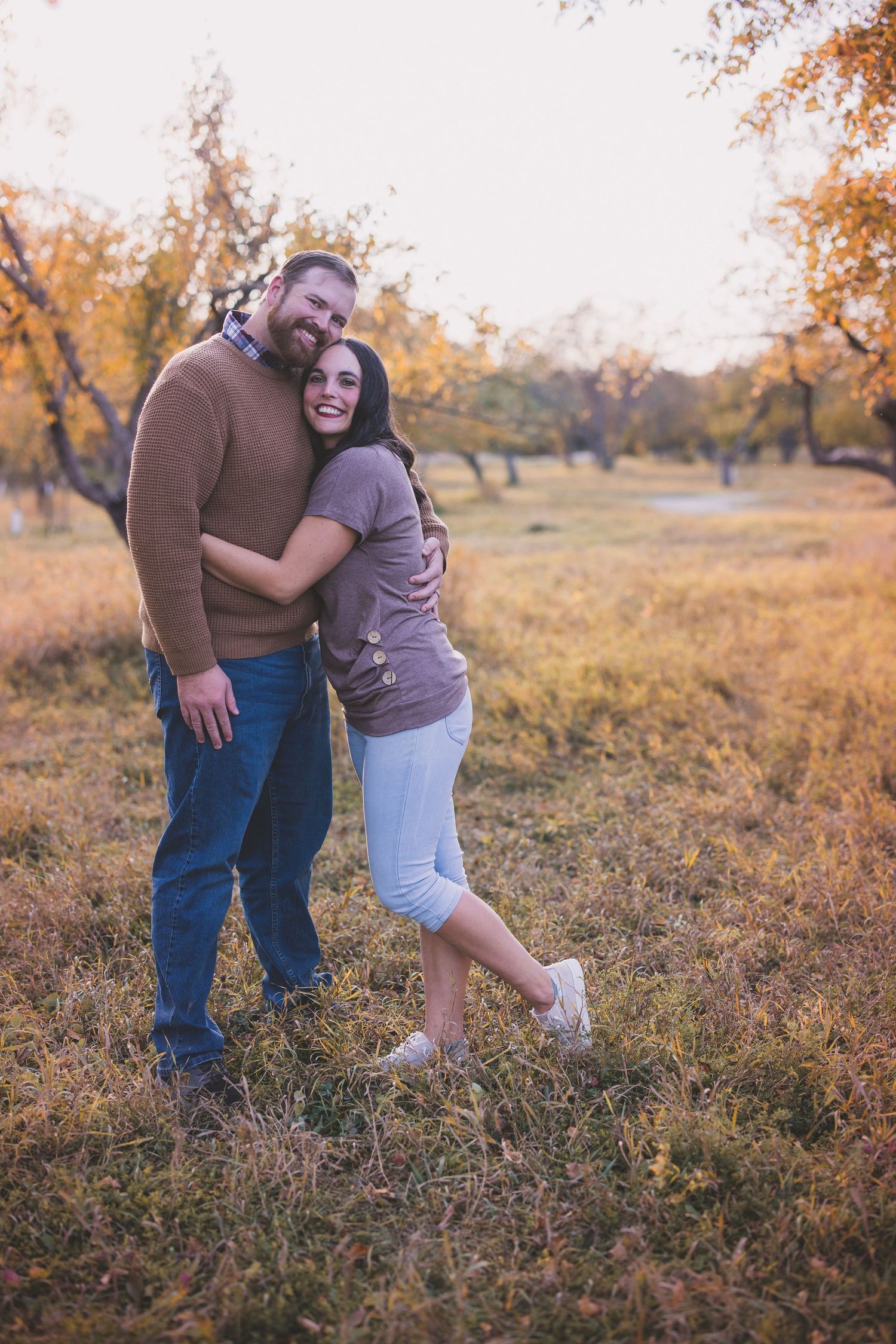 Sunset photoshoot in a golden field showing tender family moments.