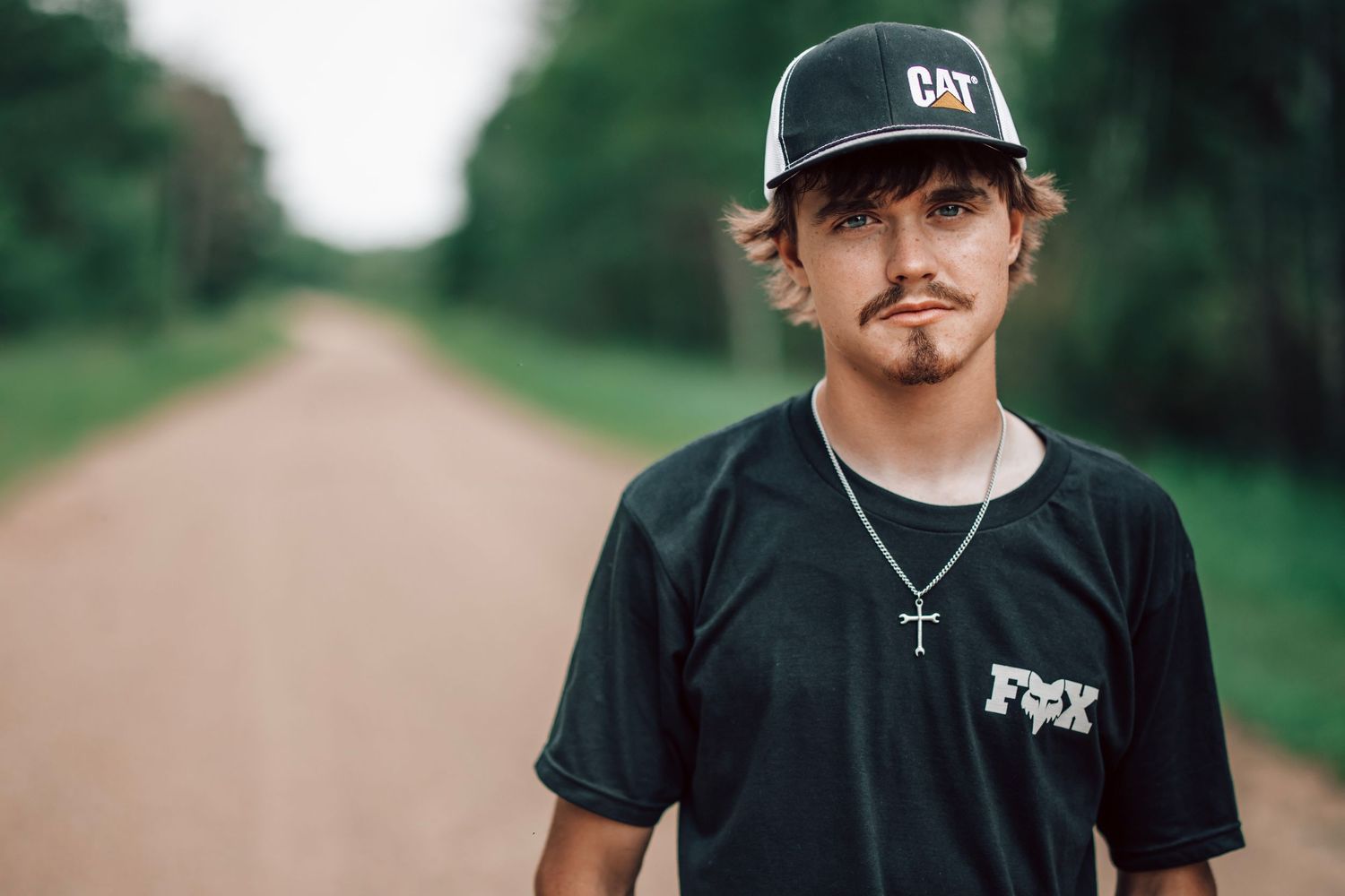 Casual outdoor portraits featuring person in black t-shirt and baseball cap.