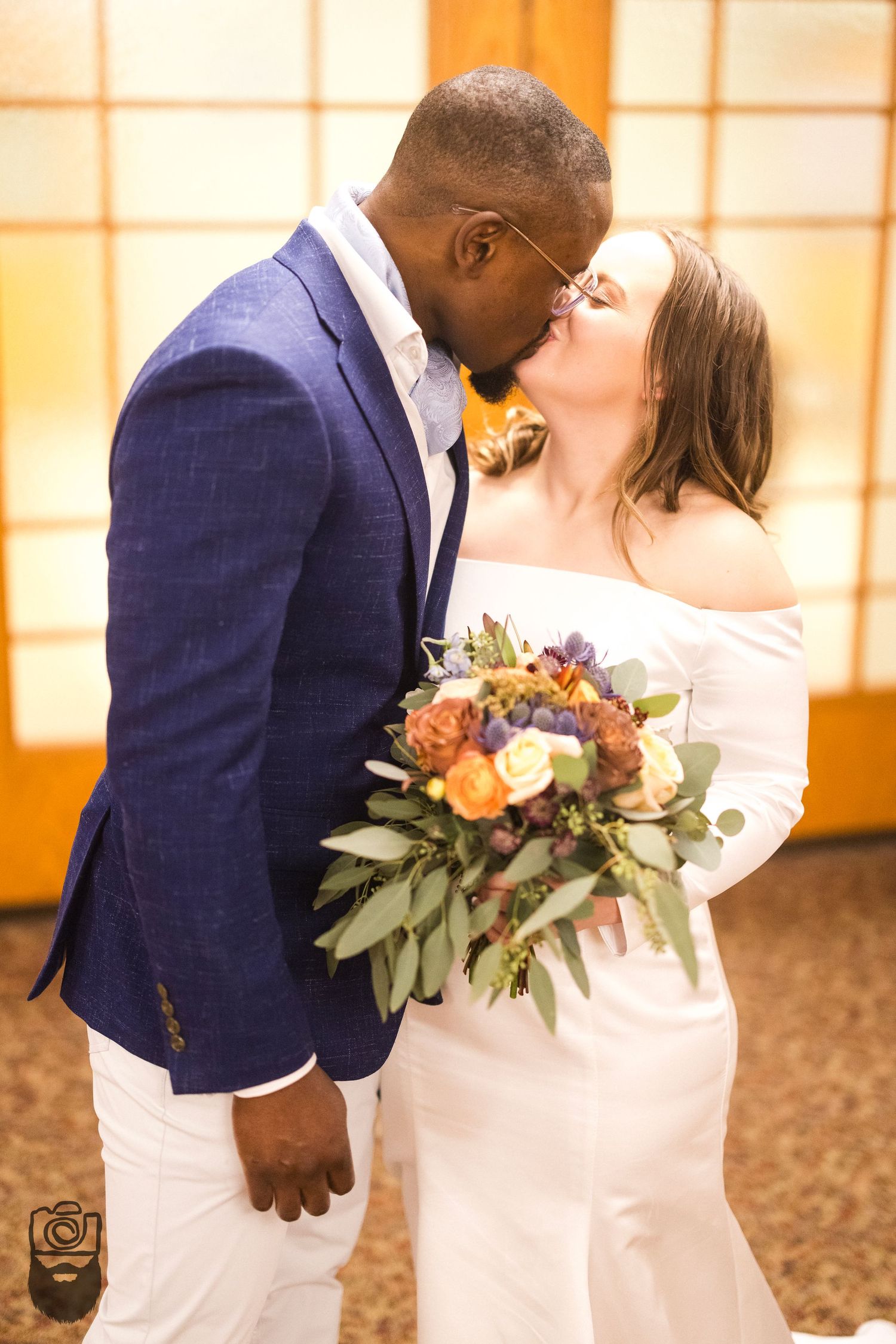 A romantic wedding moment with beautiful floral bouquet in warm lighting.