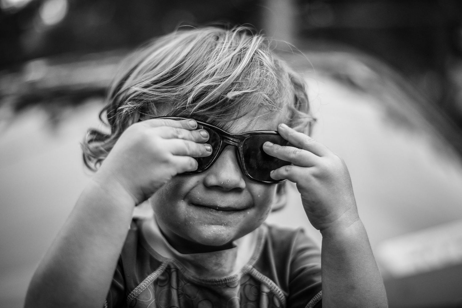 Black and white portrait series showing playful expressions.