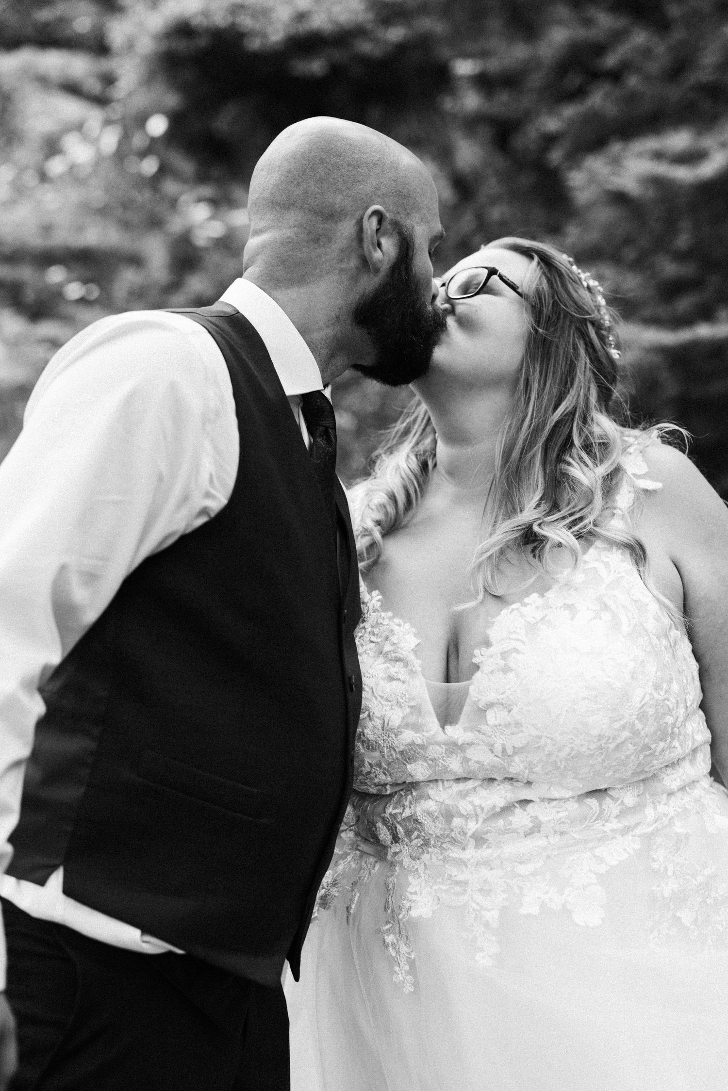 A romantic wedding couple moment captured in black and white photography.