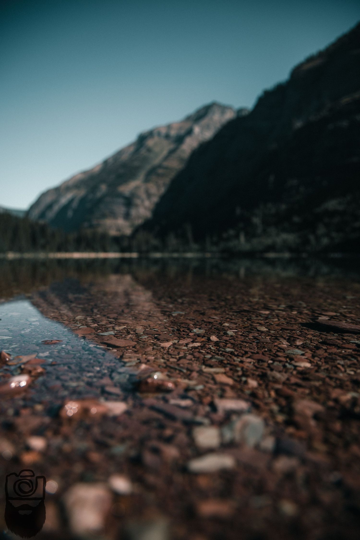 Rocky mountain terrain viewed through a low angle perspective with blurred foreground stones.