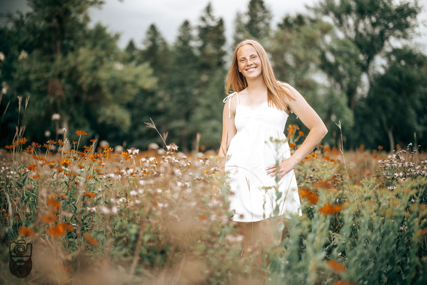 Dreamy summer portrait session in a field of wildflowers at sunset.