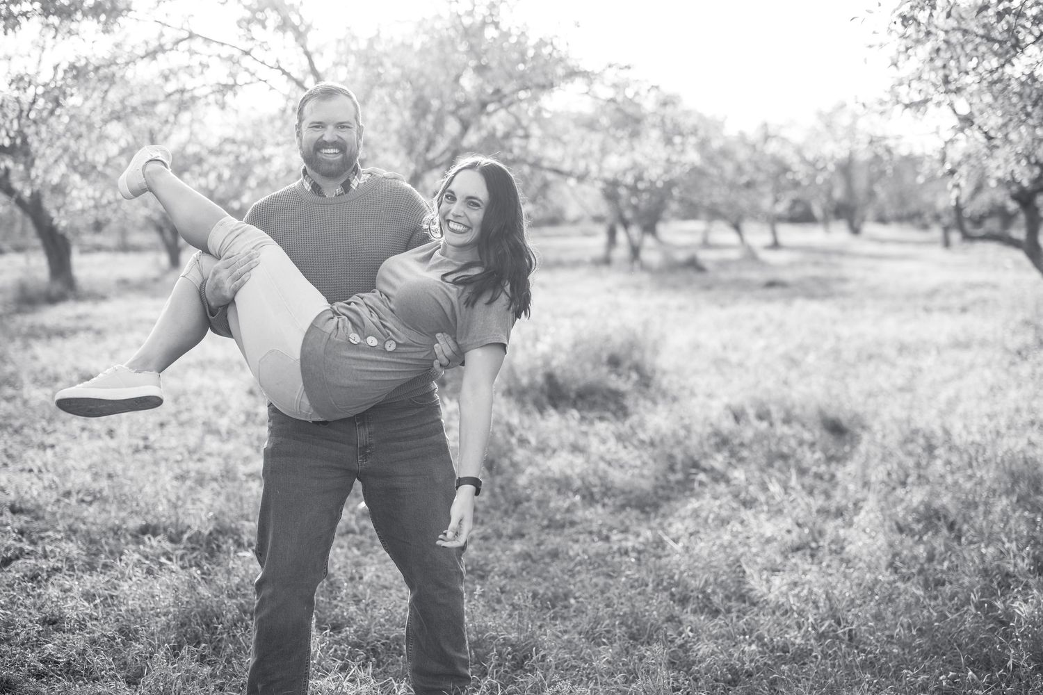 Black and white series of playful interactions in a natural outdoor setting.