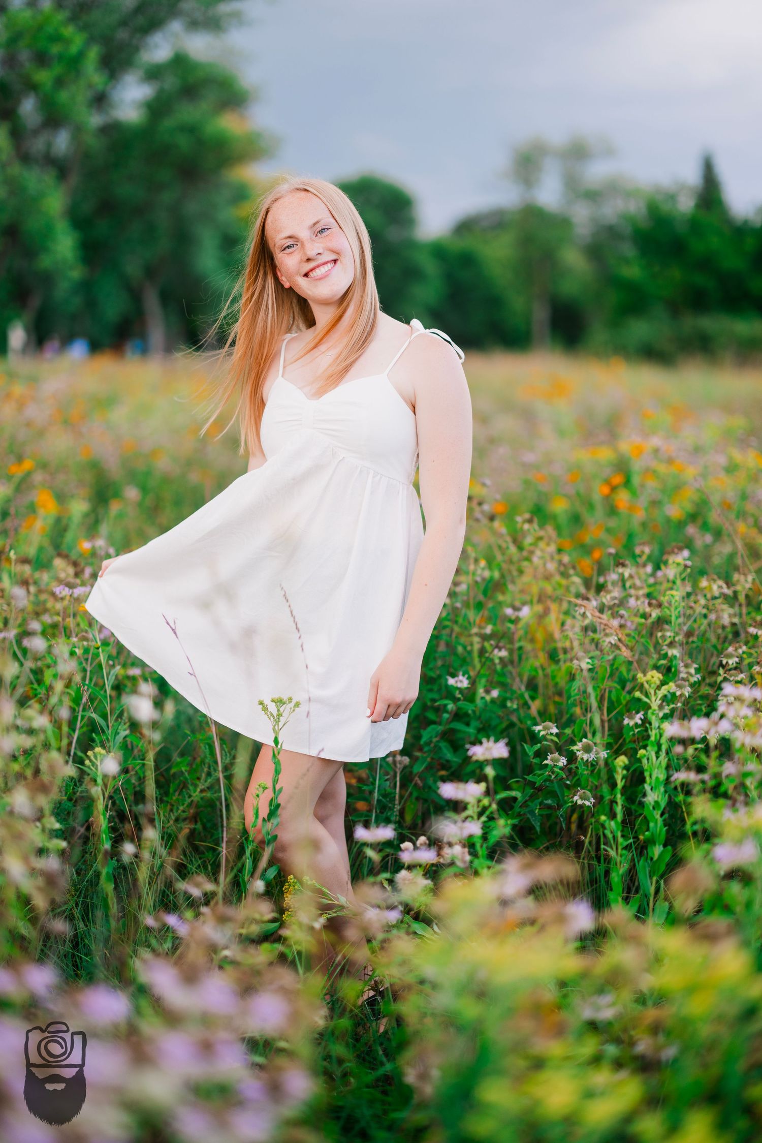 White sundress contrasts beautifully against a wildflower meadow in full bloom.