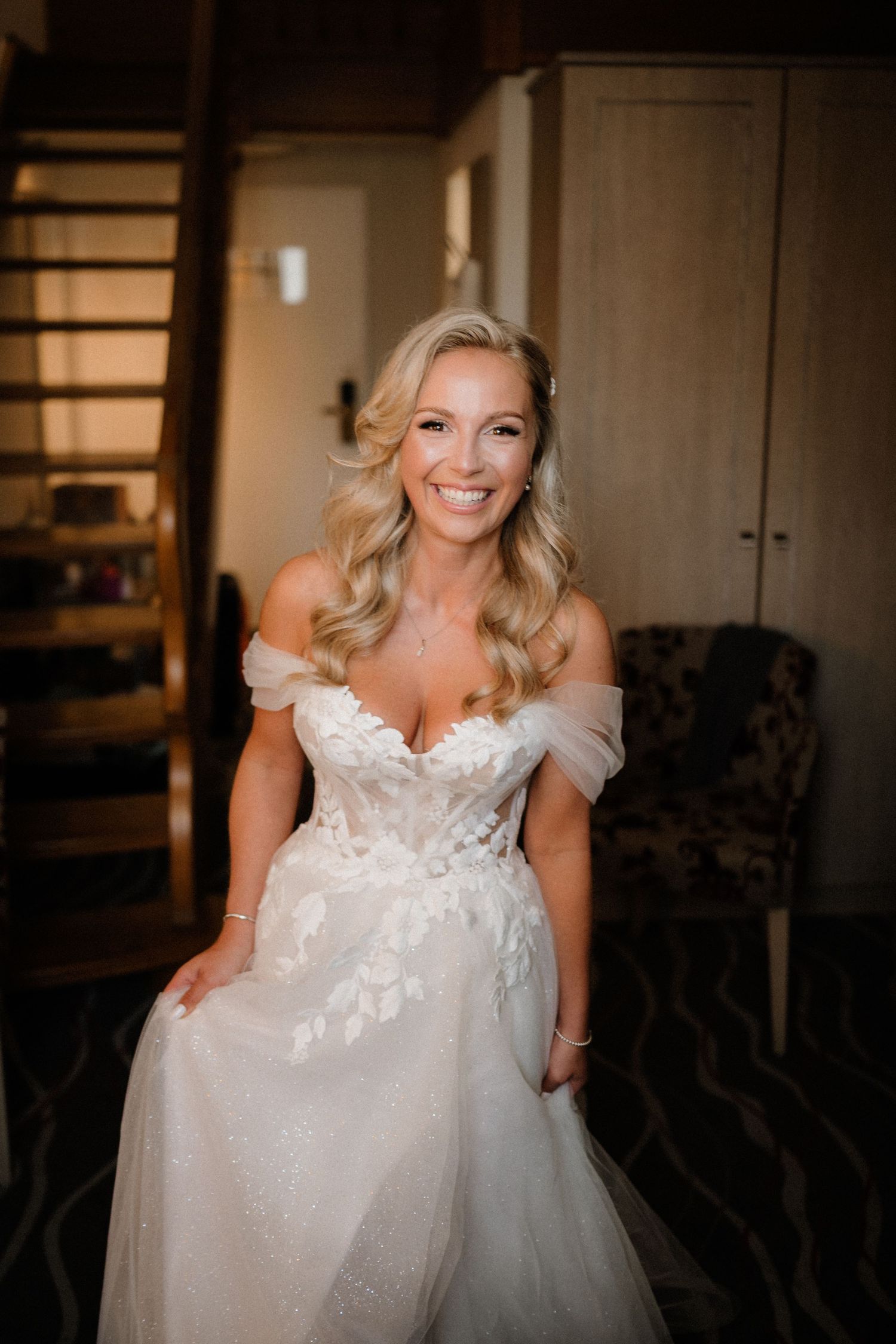Close-up details of a stunning white lace wedding dress with delicate floral appliques.