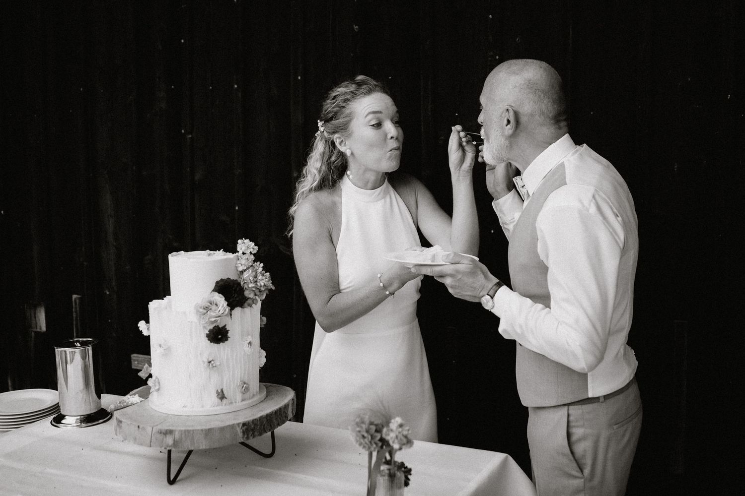 Black and white photo of couples dancing at a rustic barn wedding reception.