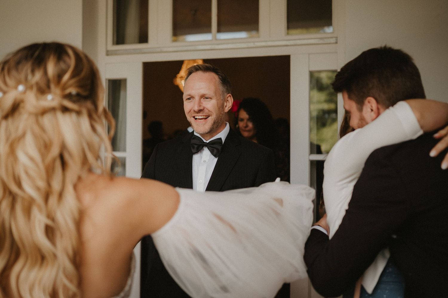 Wedding guests share joyful moments during reception celebration.