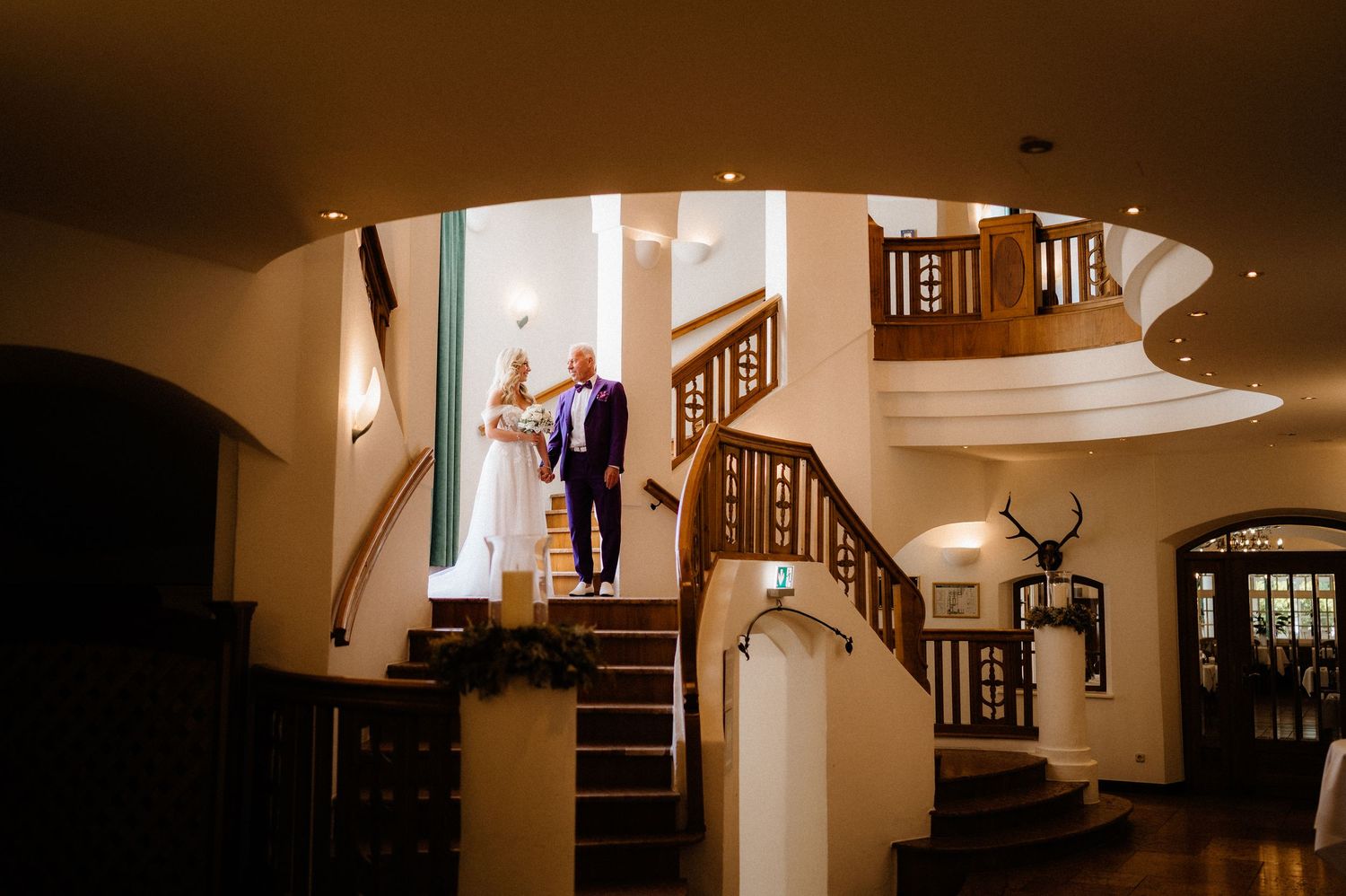 A sequence of dark hallway interior shots with dramatic lighting and wooden banisters.