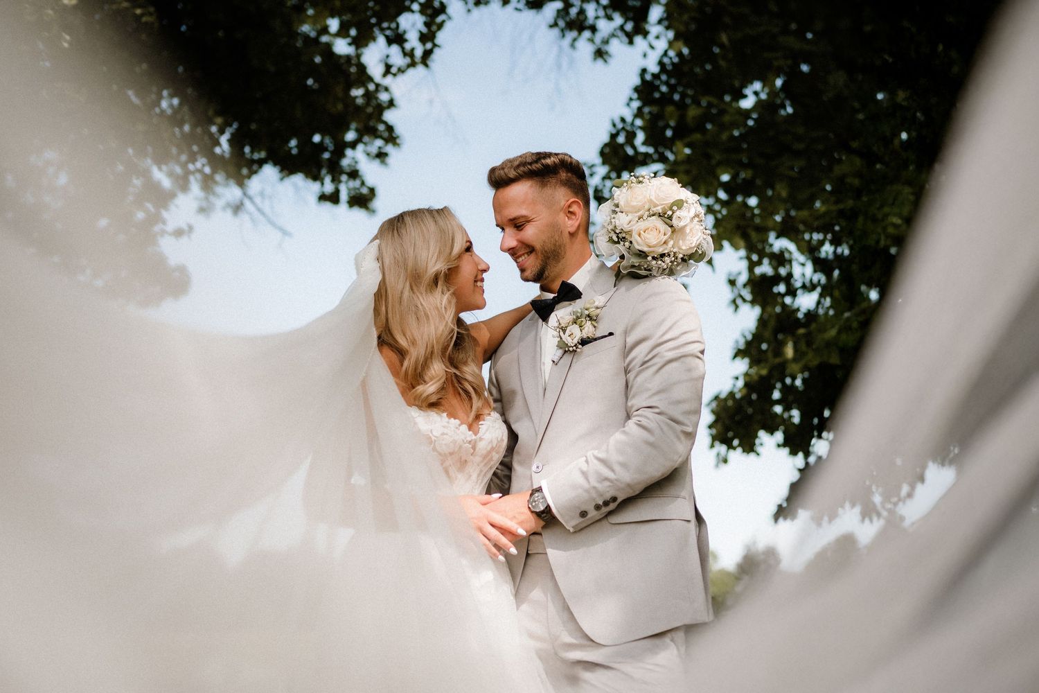 Romantic outdoor wedding portraits captured through a creative vignette lens effect.
