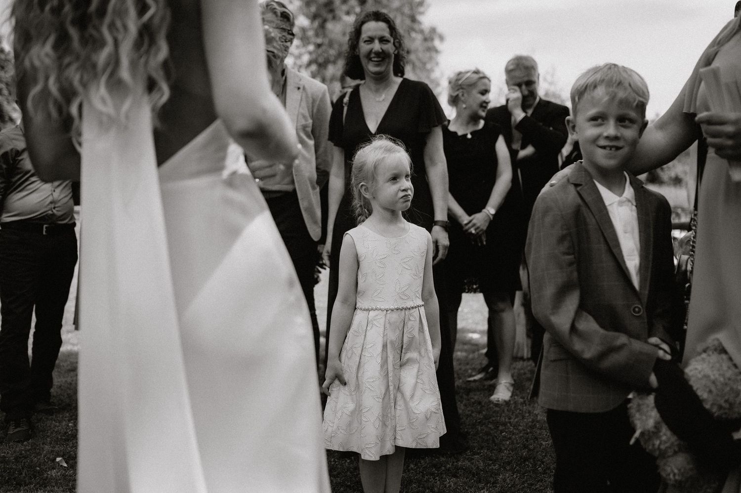 Candid moments of joy and laughter during an outdoor wedding celebration.