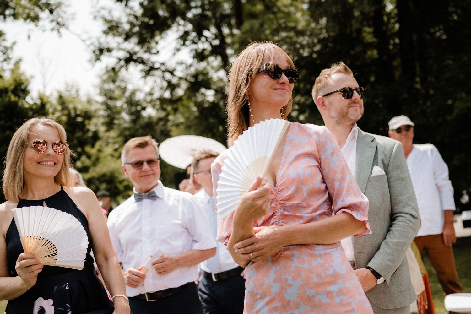 Wedding guests enjoy a lively outdoor celebration with dancing and laughter.