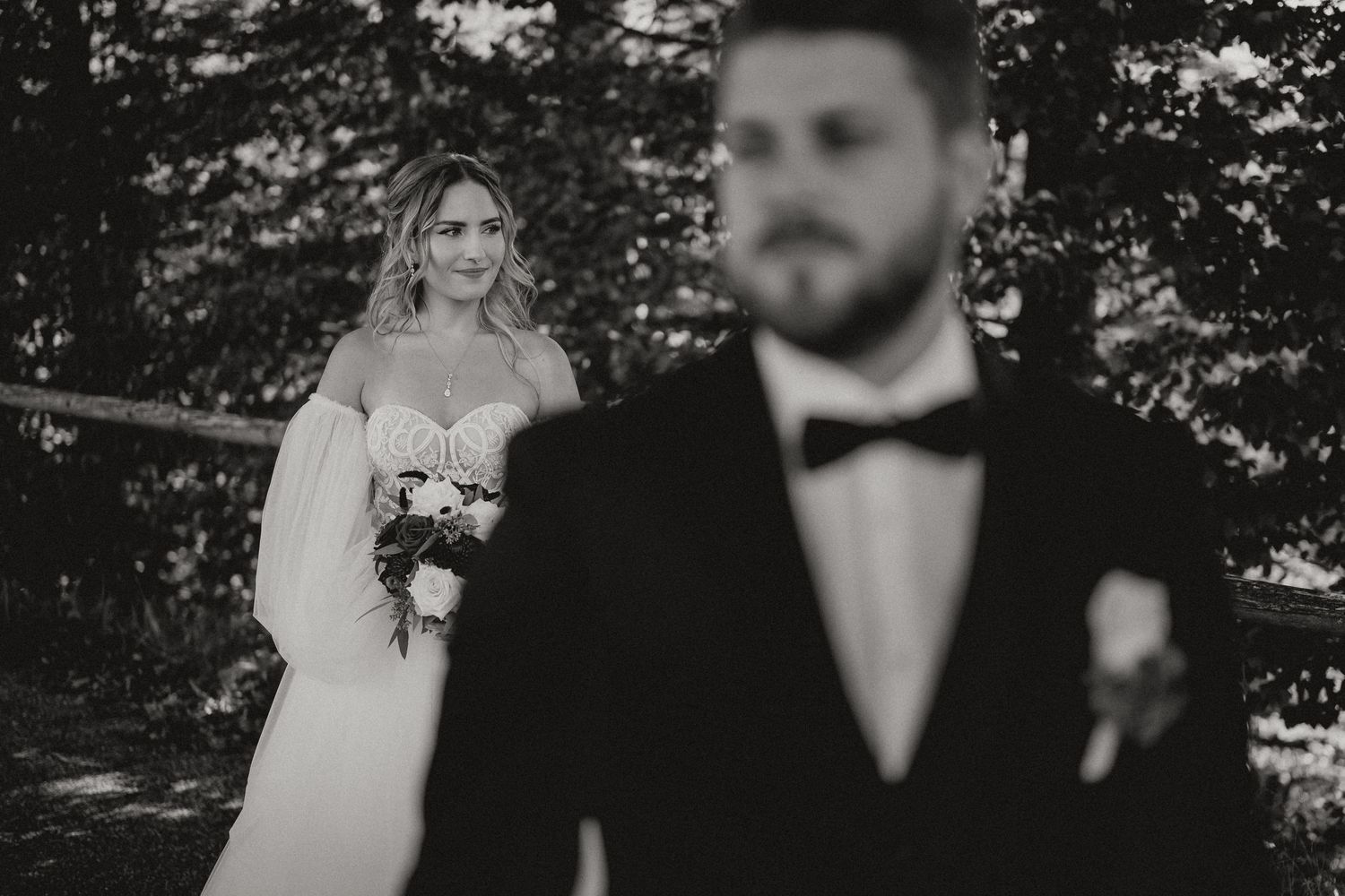 Black and white wedding portraits taken in a natural forest setting.