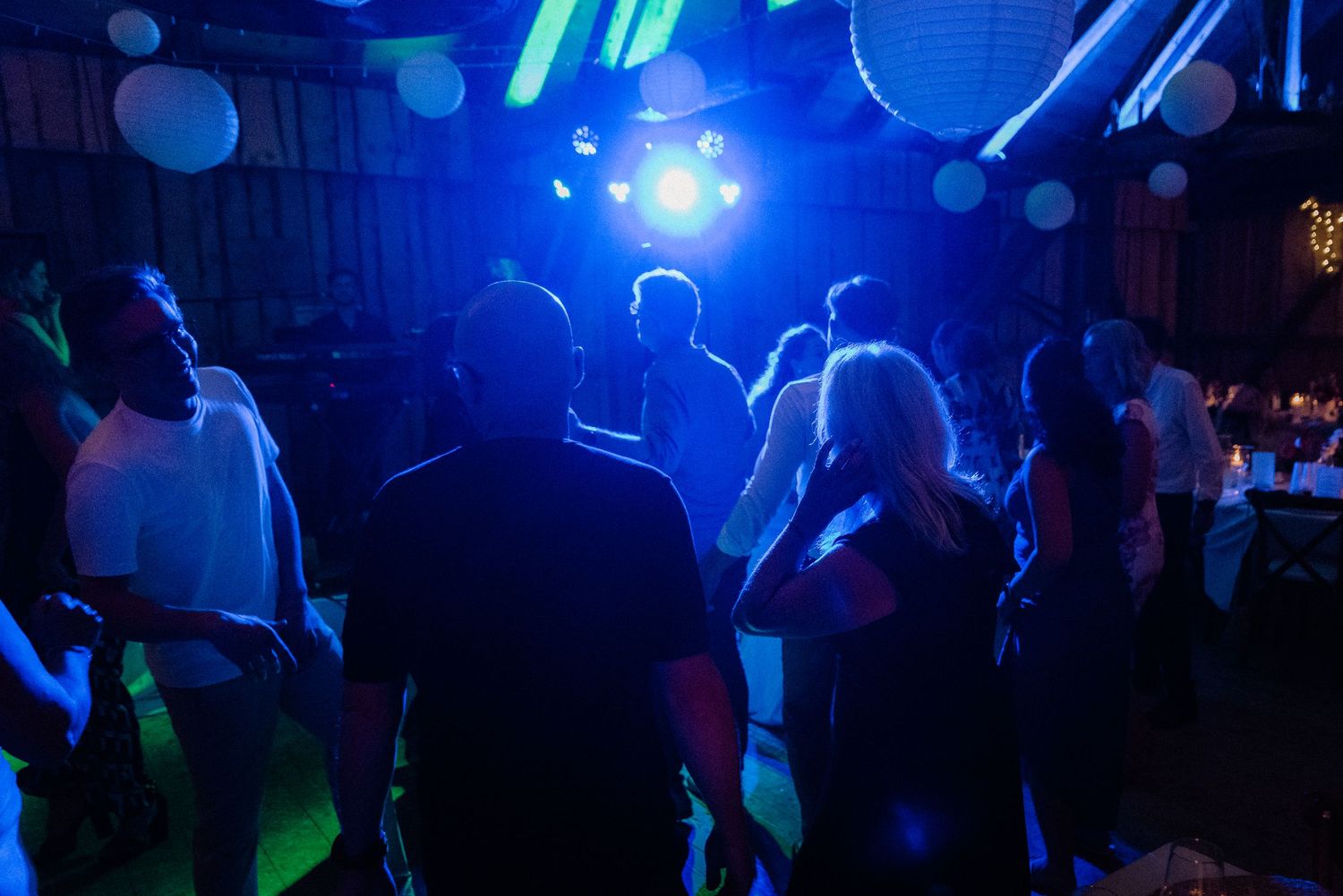 Dance floor illuminated with blue and purple lighting creating a nightclub atmosphere.