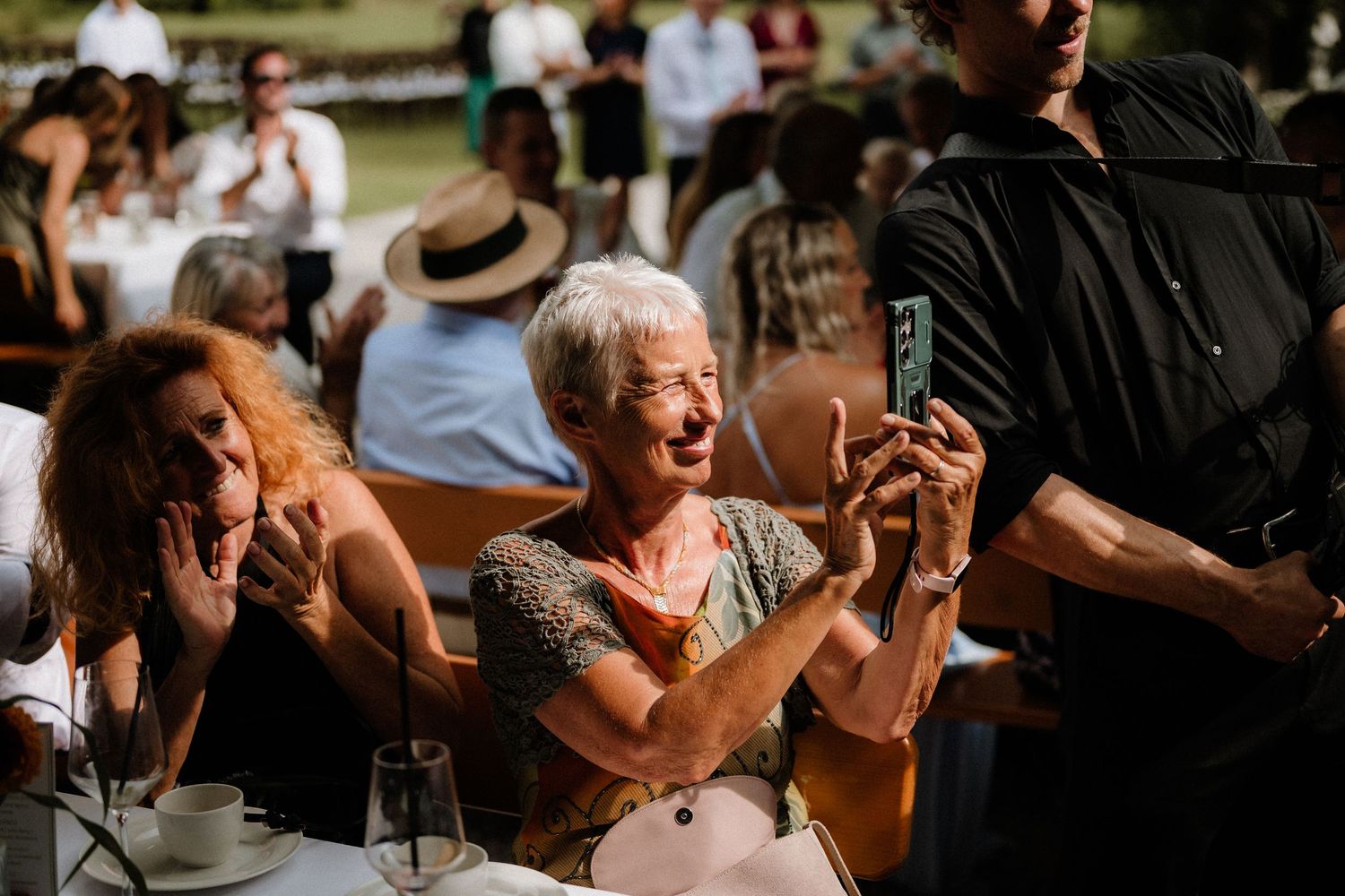 Wedding guests play a fun outdoor game of Connect Four during a summer reception.