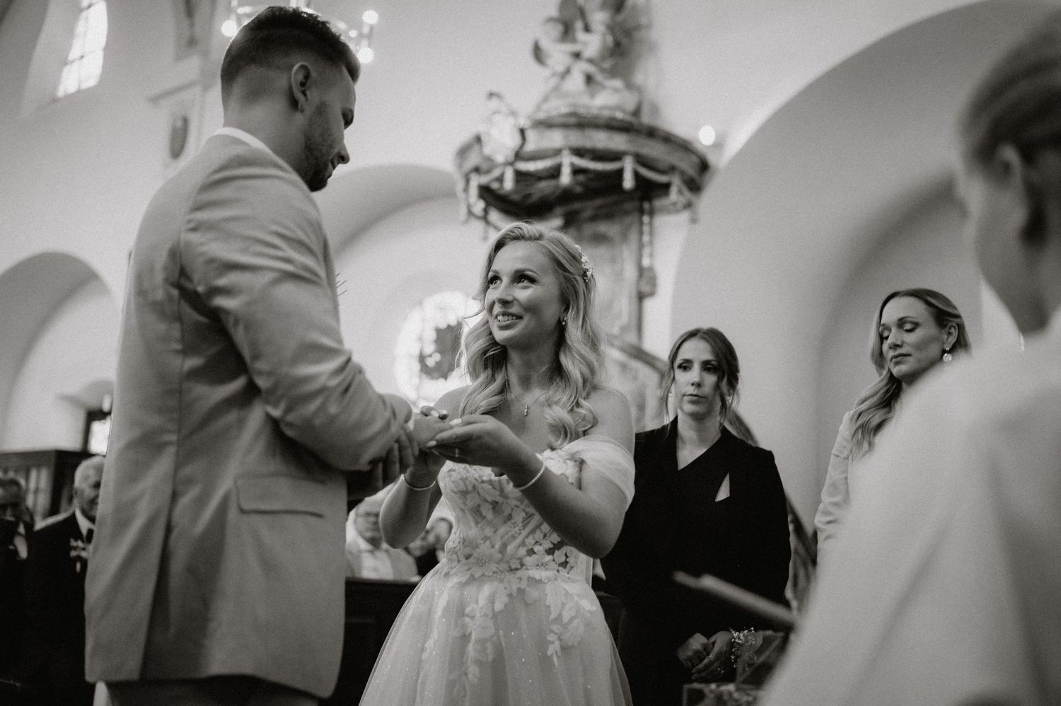 Black and white photo series showing candid reactions during a church wedding ceremony.