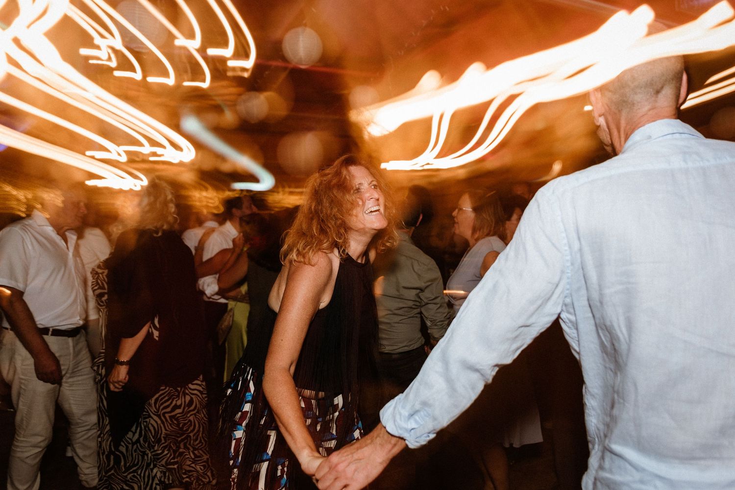 Lively dance floor scene with motion blur and warm lighting effects.