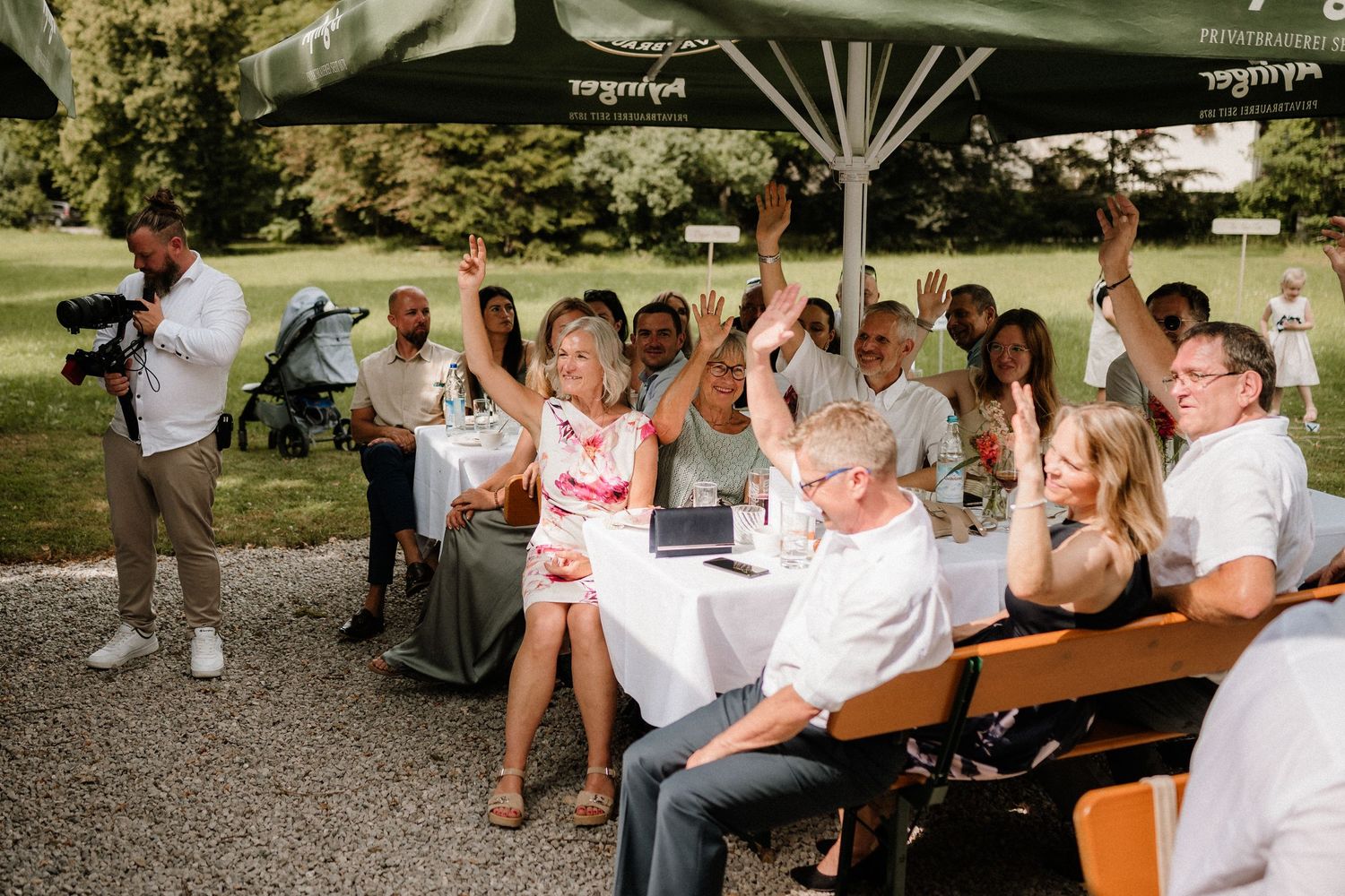 People gathered at outdoor tables during a summer celebration event.