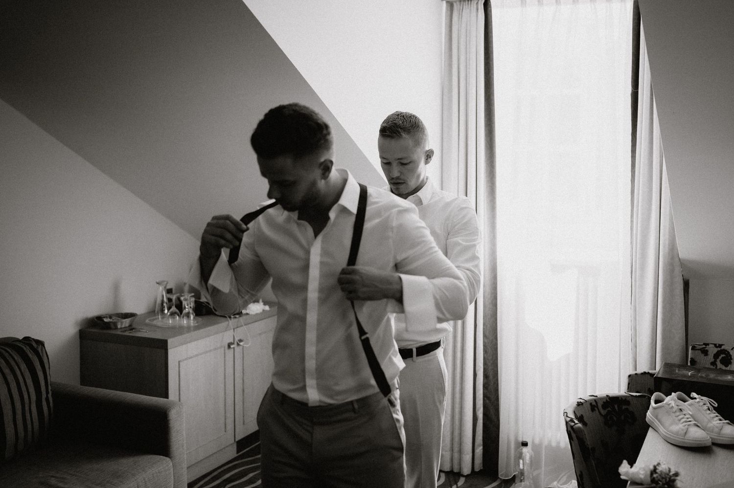 Black and white image of wedding preparation in a hotel room.
