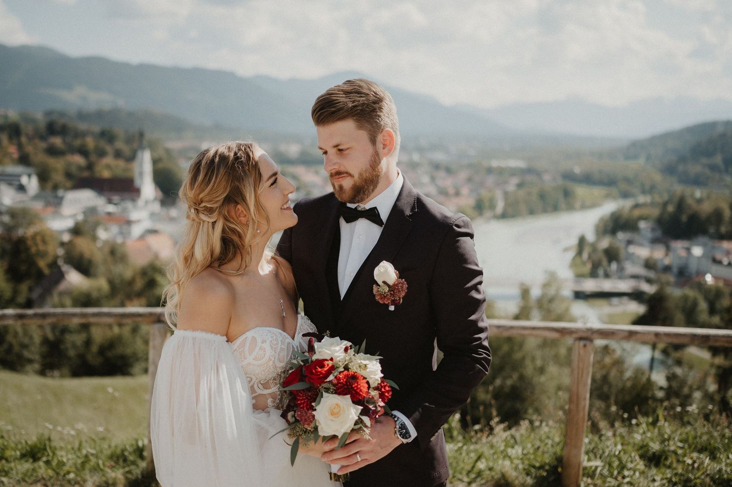 A romantic outdoor wedding photoshoot with mountains and scenic views in the background.