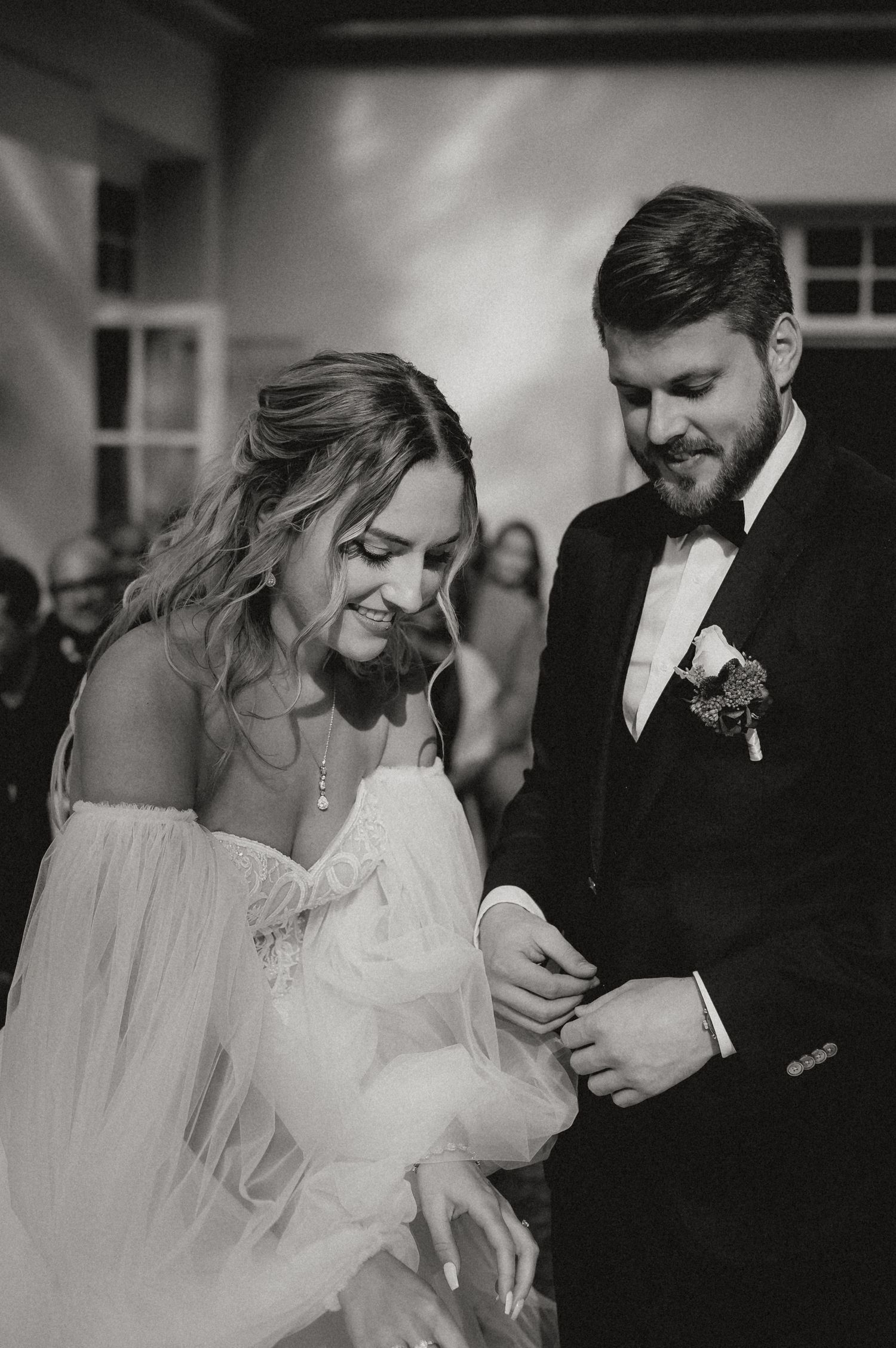A candid wedding moment showing laughter and joy between the newlyweds.