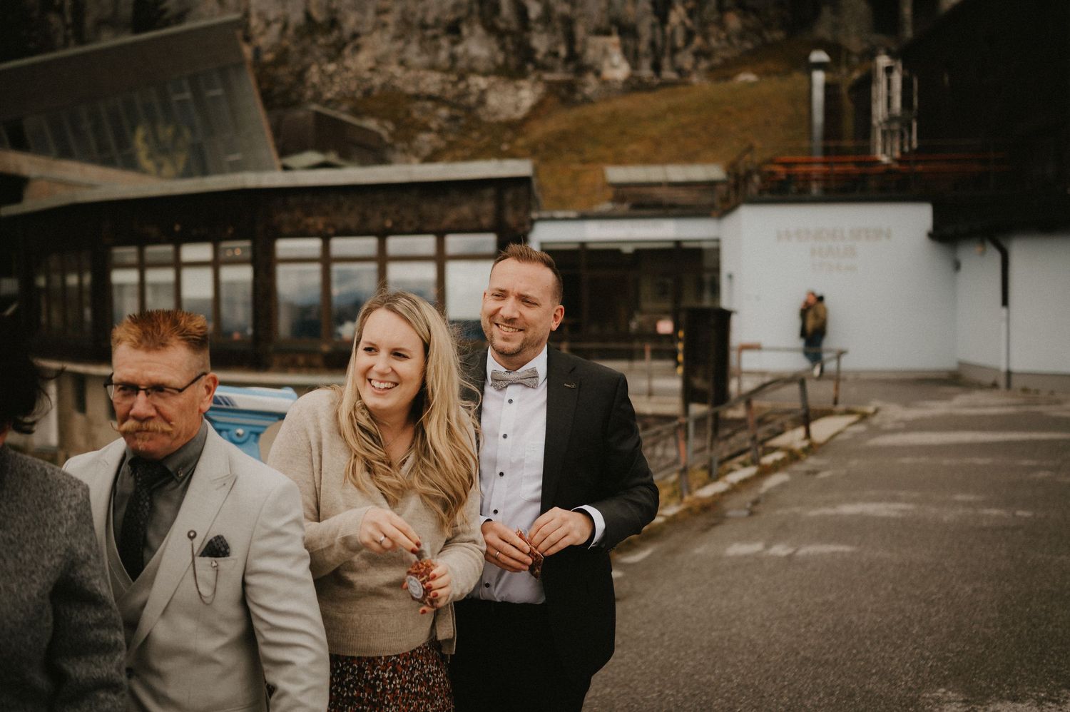 Wedding party poses together on a rustic path surrounded by nature.