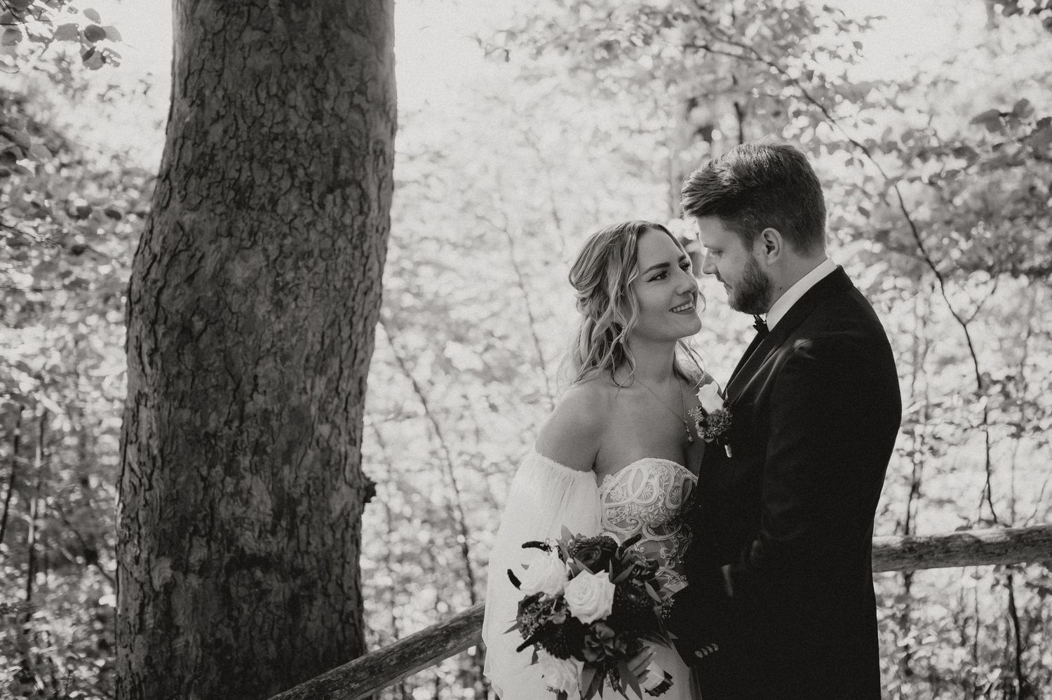 Intimate wedding moments captured in a wooded forest setting.