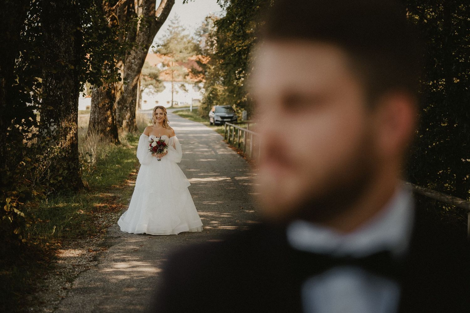 Artistic wedding photography composition with natural pathway and trees.