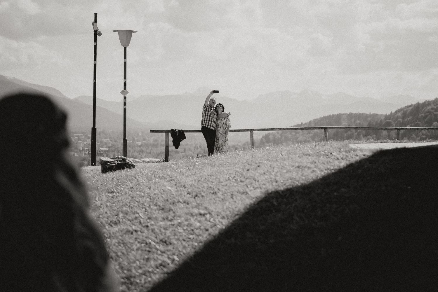 Black and white artistic wedding photography in a natural outdoor setting.