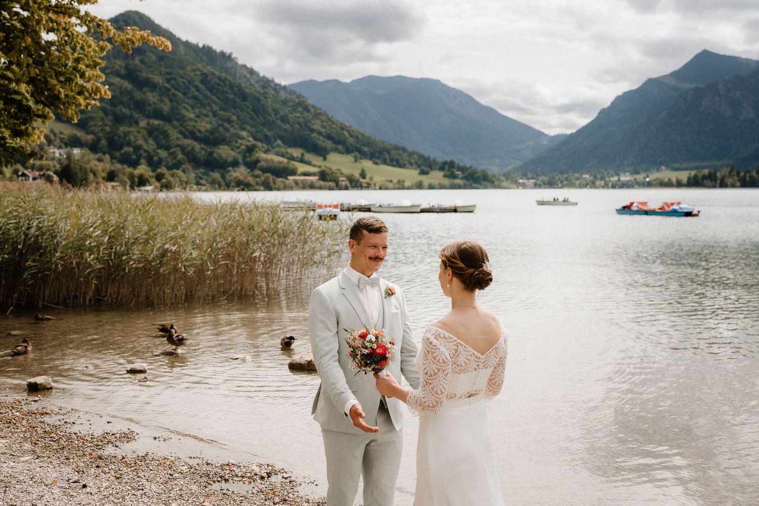 Scenic lakeside wedding setting with mountain backdrop and autumn foliage.