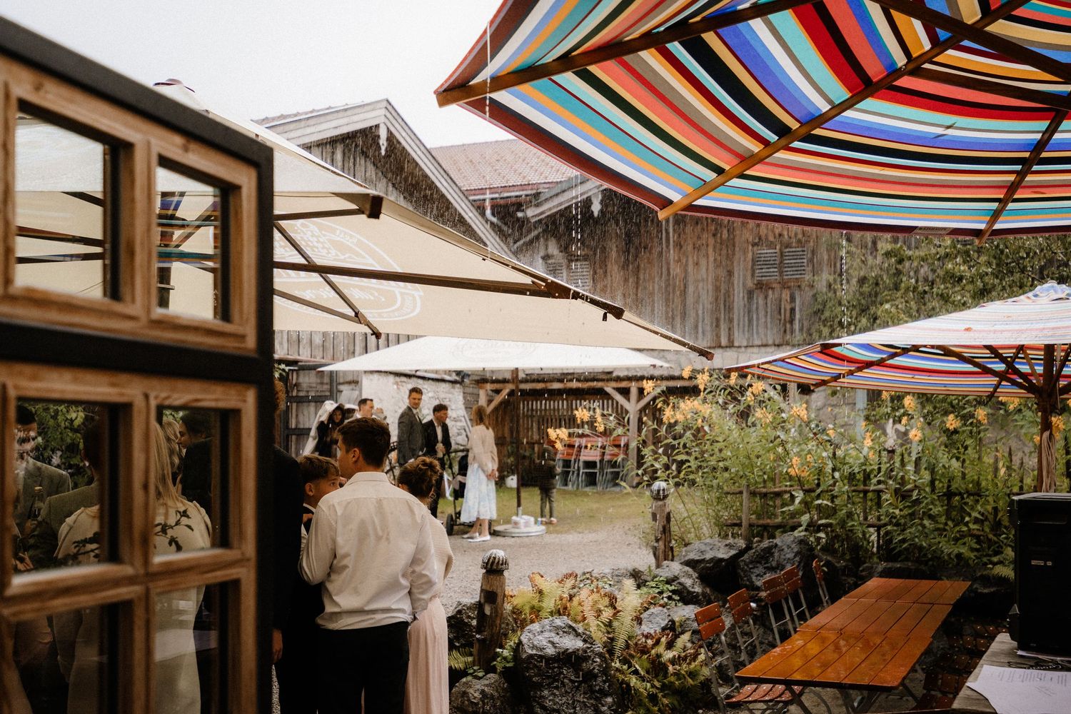 Outdoor venue with colorful striped awnings and umbrellas.