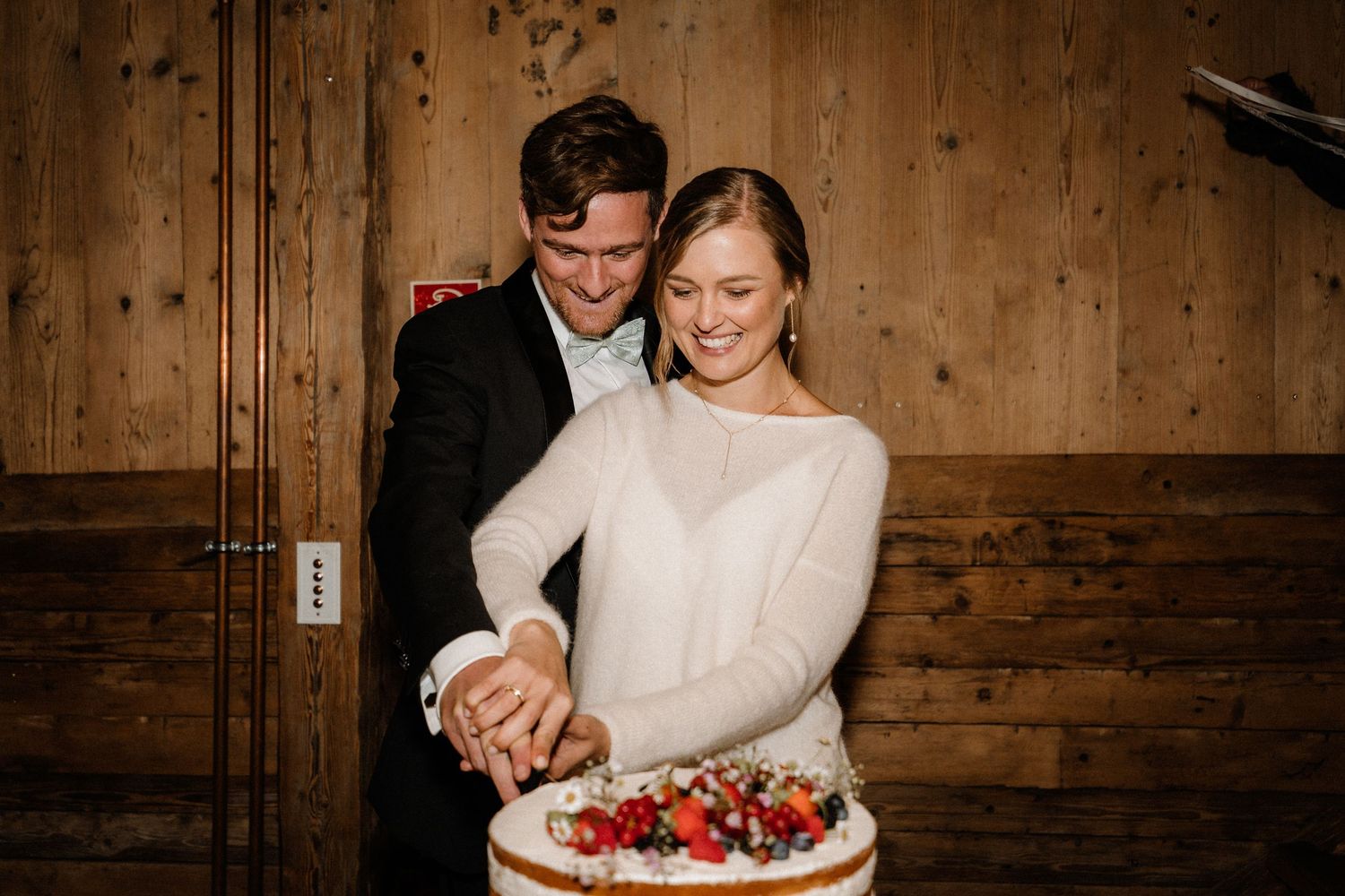 Elegant dessert display with fresh berries and cream in a rustic wooden setting.