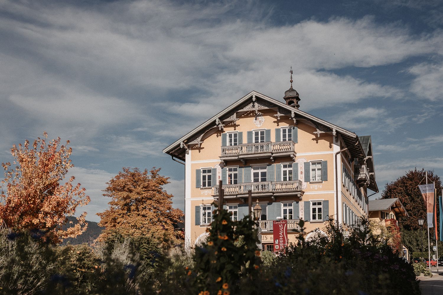 A panoramic view of traditional Bavarian houses with ornate facades against a dramatic cloudy sky.
