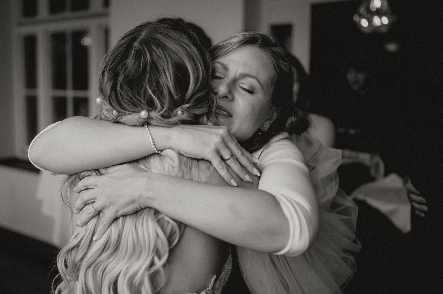 Emotional wedding reception moments captured in black and white photography.