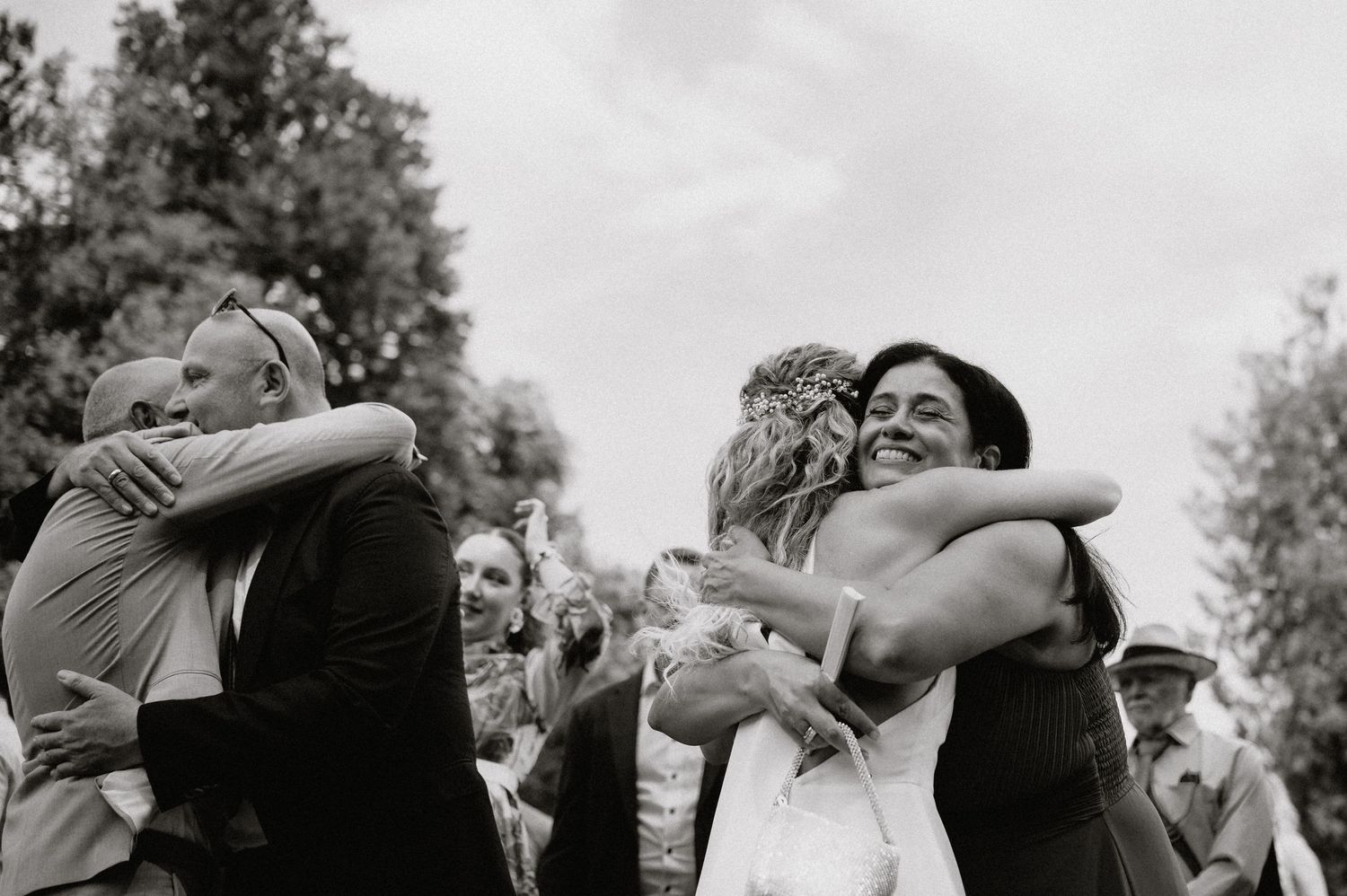 Black and white photo series of emotional wedding embraces and celebrations.