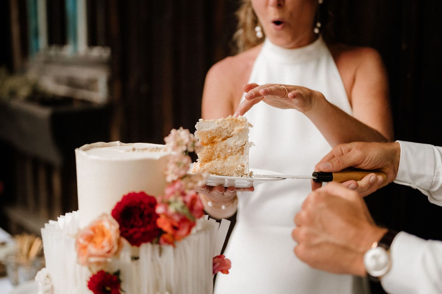 Close-up shots of a couple sharing bites of wedding cake during their reception celebration.