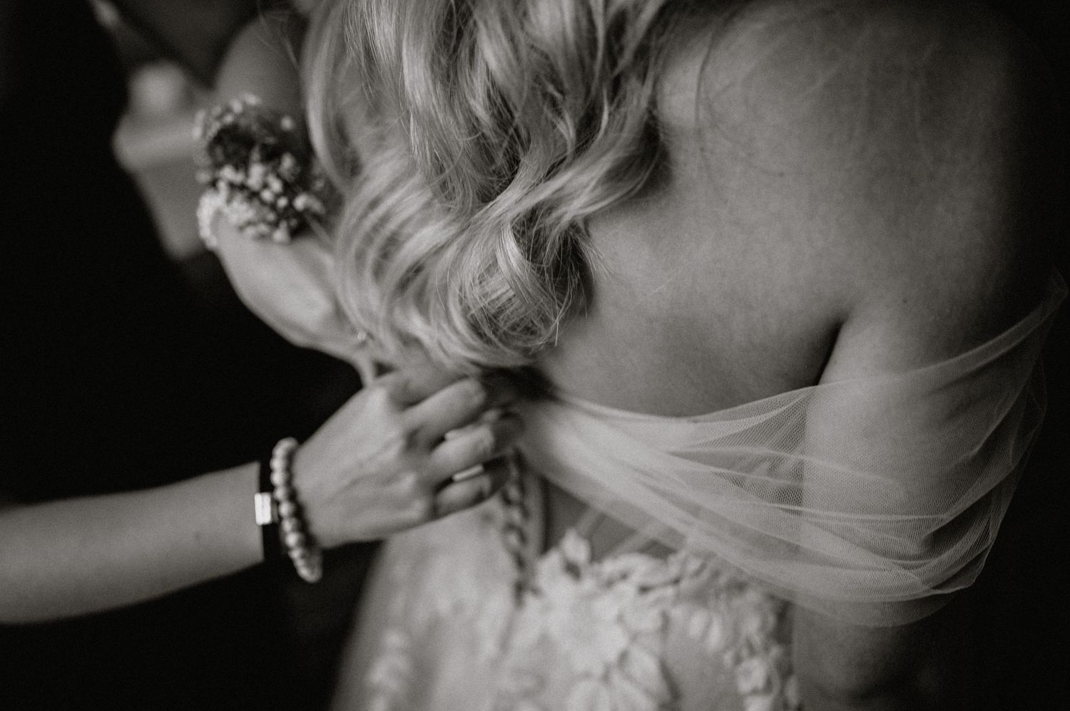 Artistic black and white close-up shots of bridal hair styling and dress details.