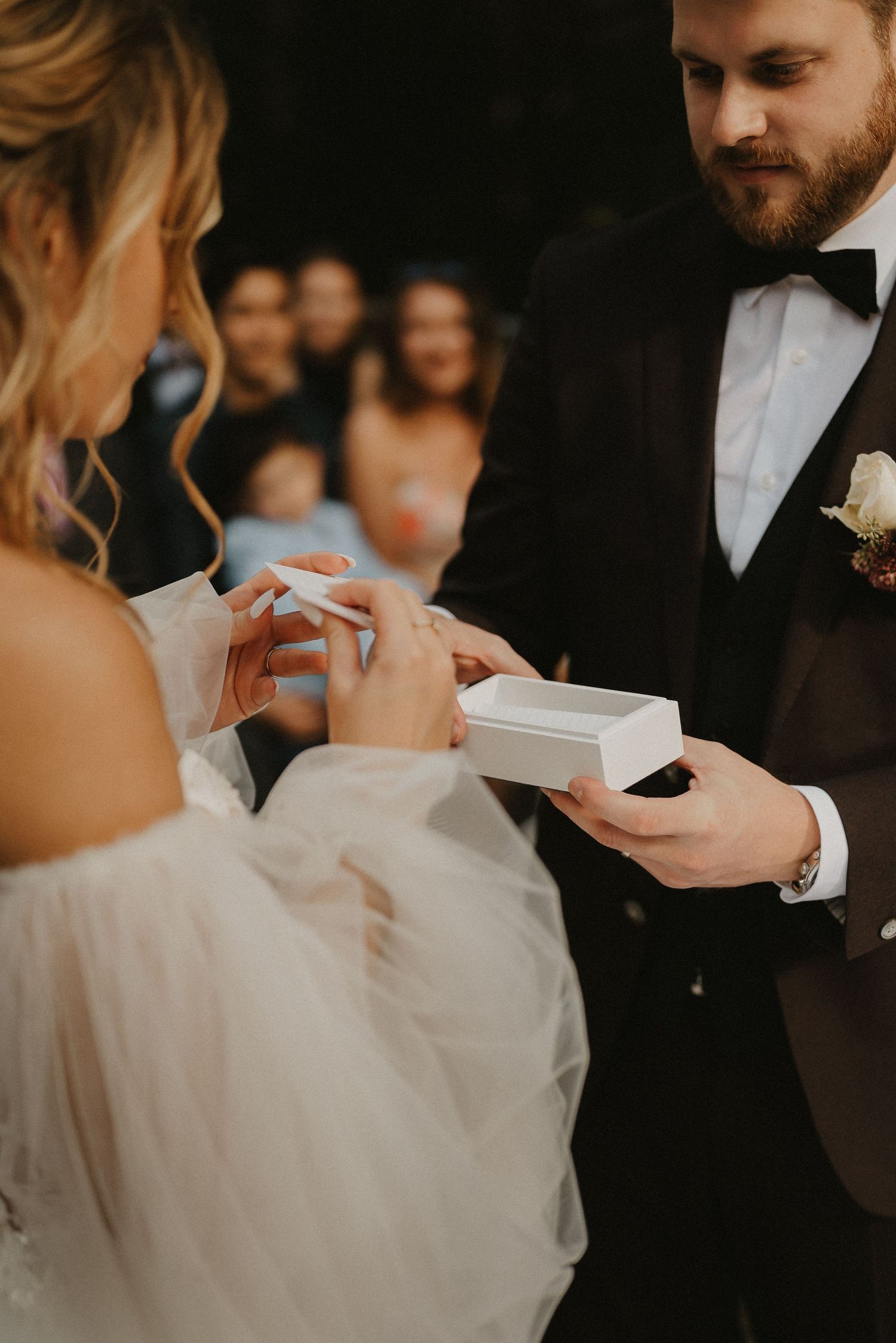 Close-up details of a wedding ceremony moment with soft natural lighting.
