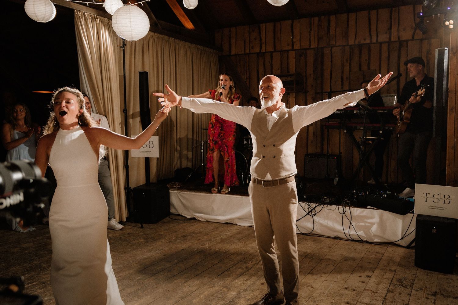 Joyful dancing captured during a rustic barn wedding celebration.