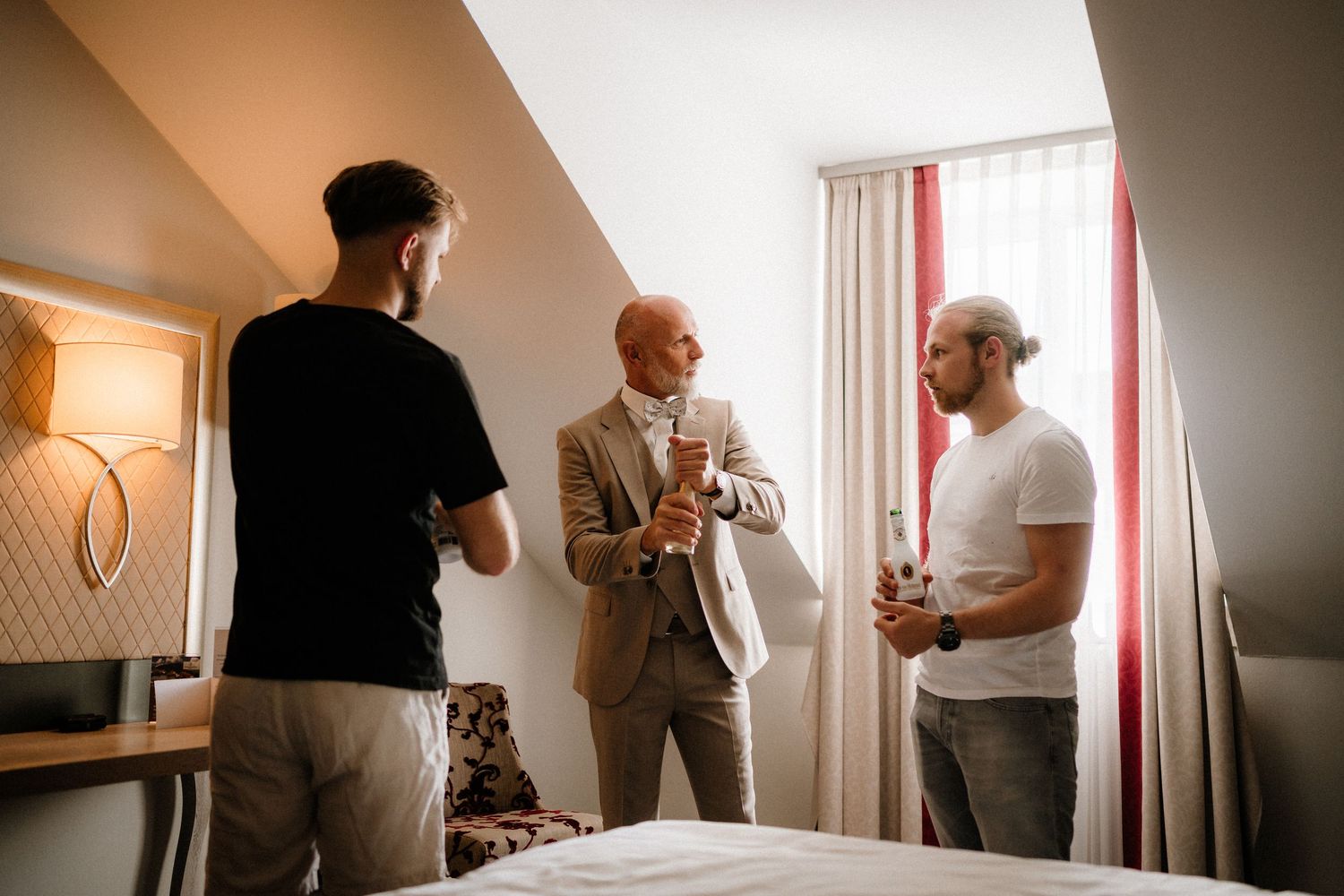 Getting ready scene in a room with dramatic lighting and red curtains.