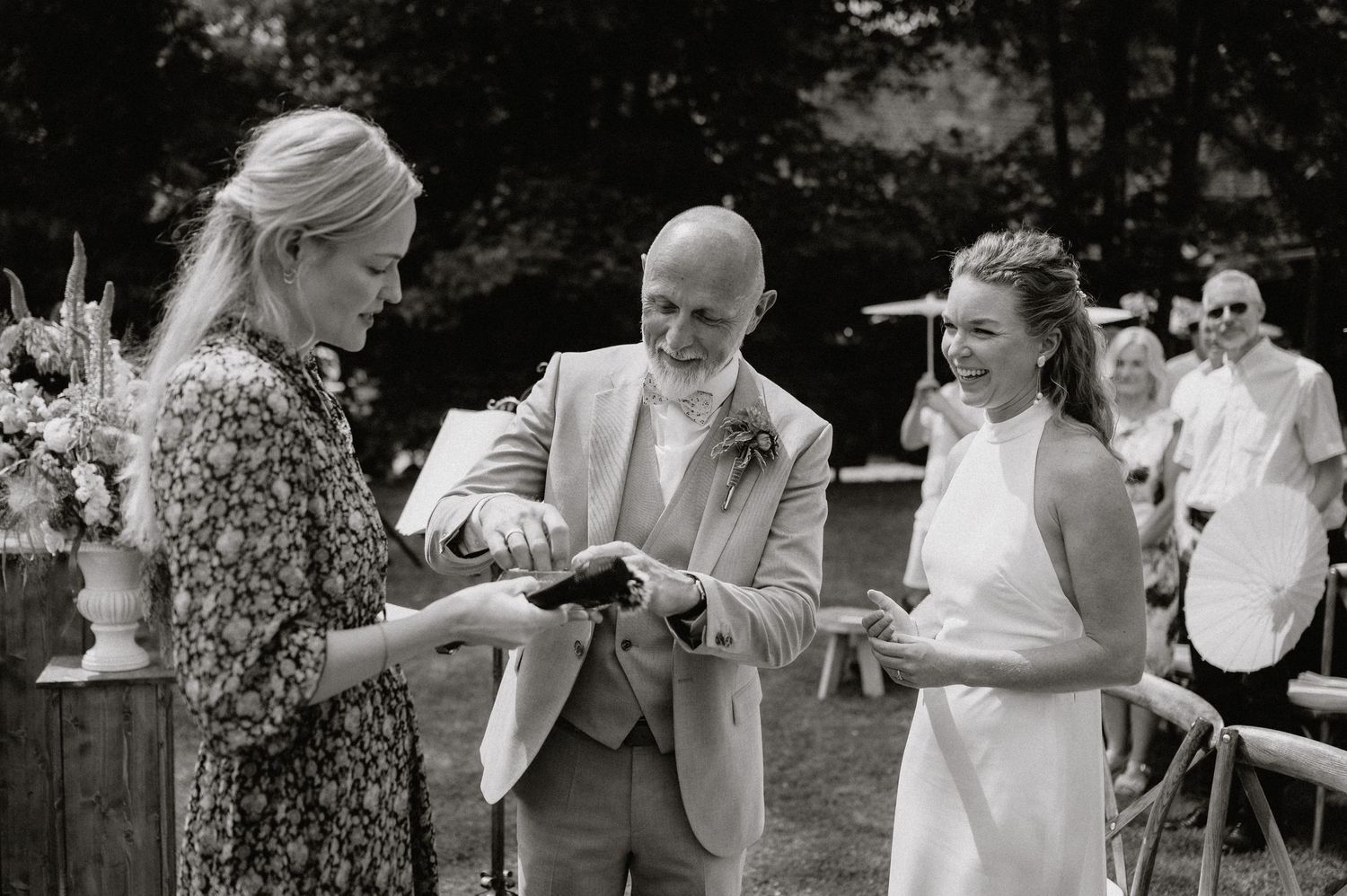 Wedding guests dance and celebrate during an outdoor reception.
