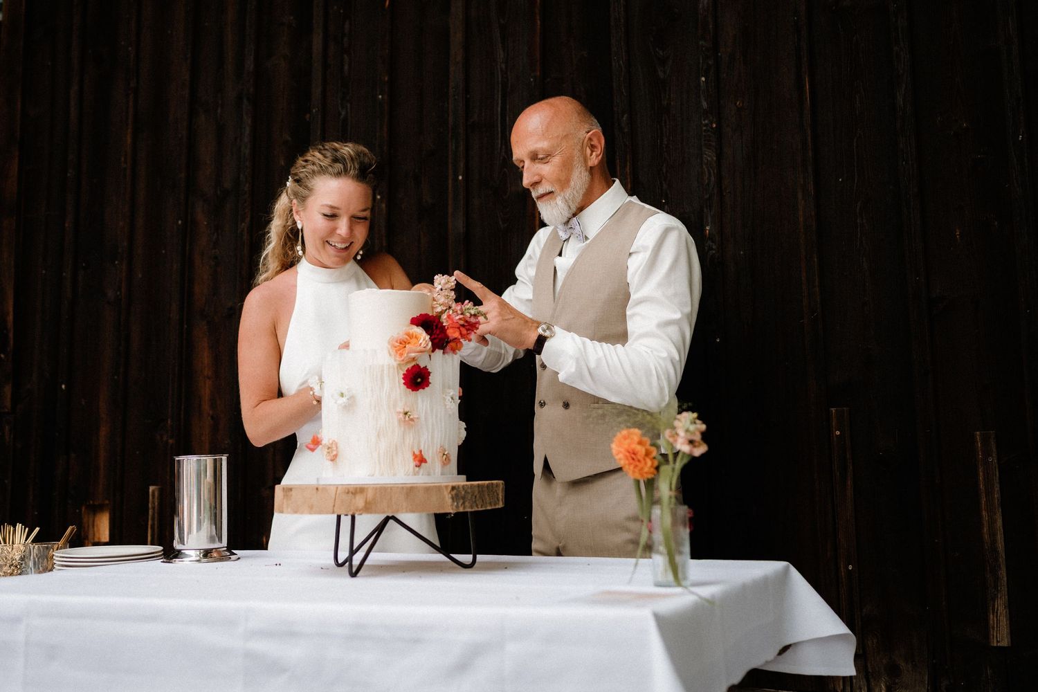 The newlyweds share cake during their traditional wedding reception cake cutting moment.